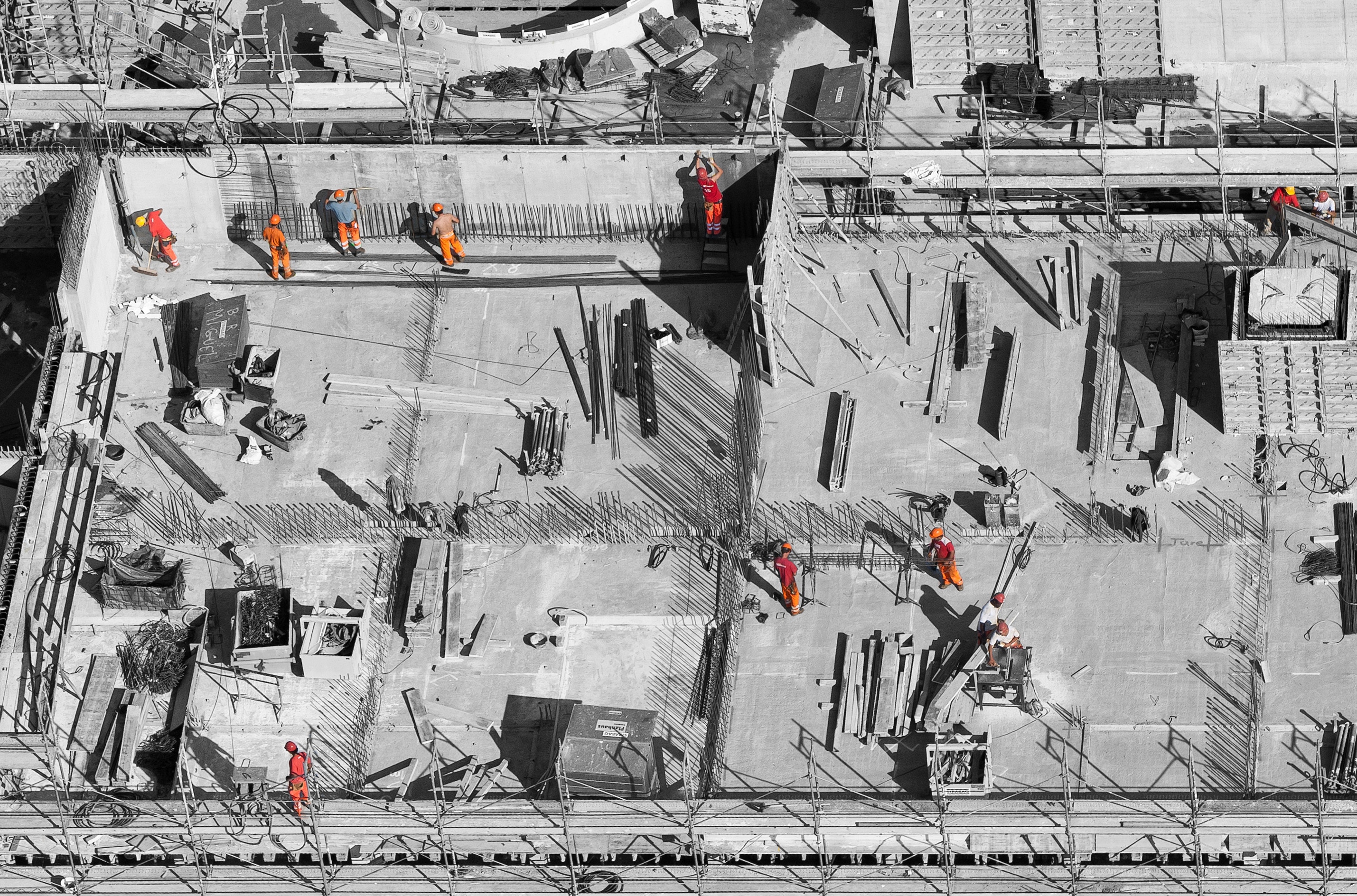 Construction workers on a building site with rebar HD Wallpaper