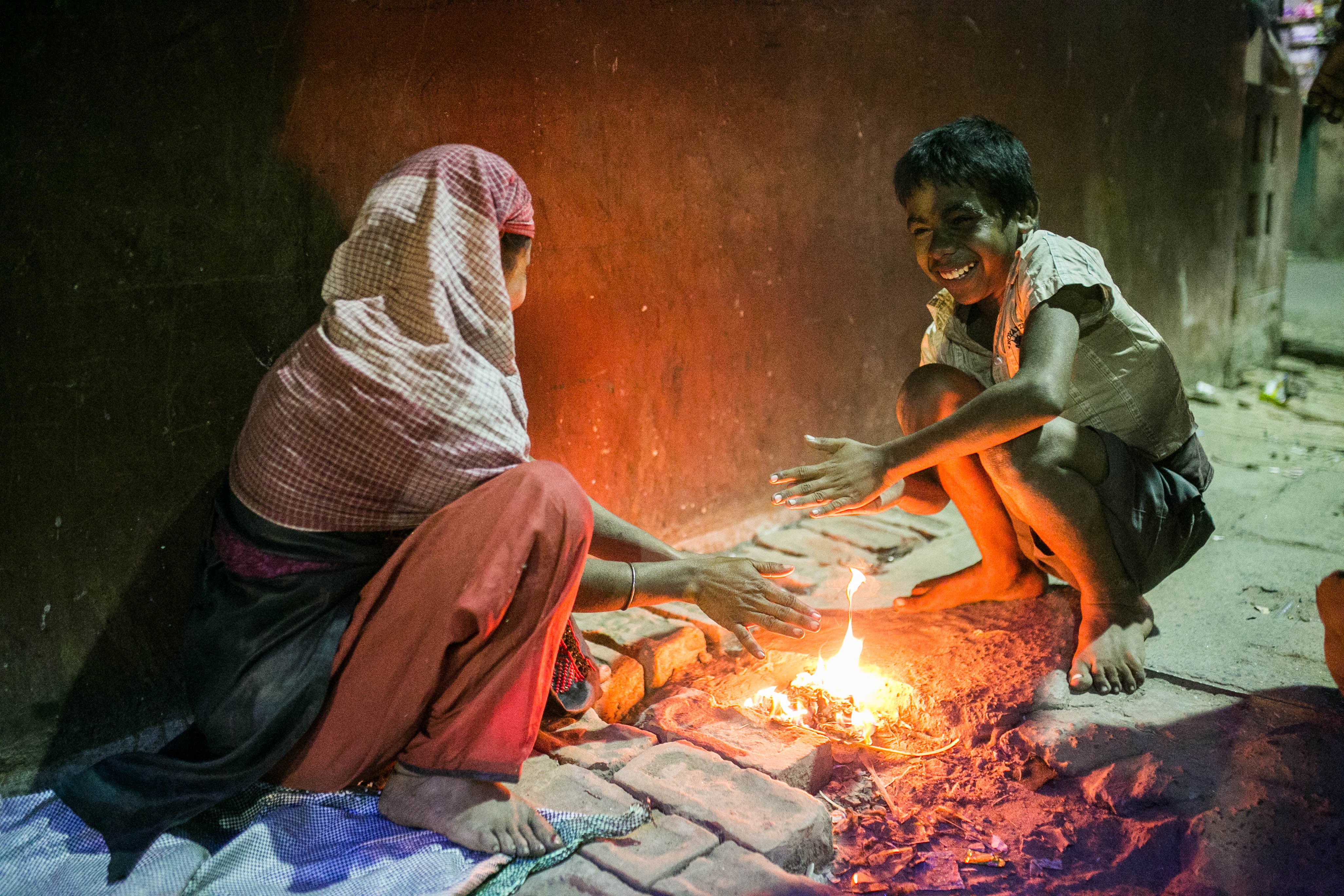 Children warming hands by a fire in India HD Wallpaper