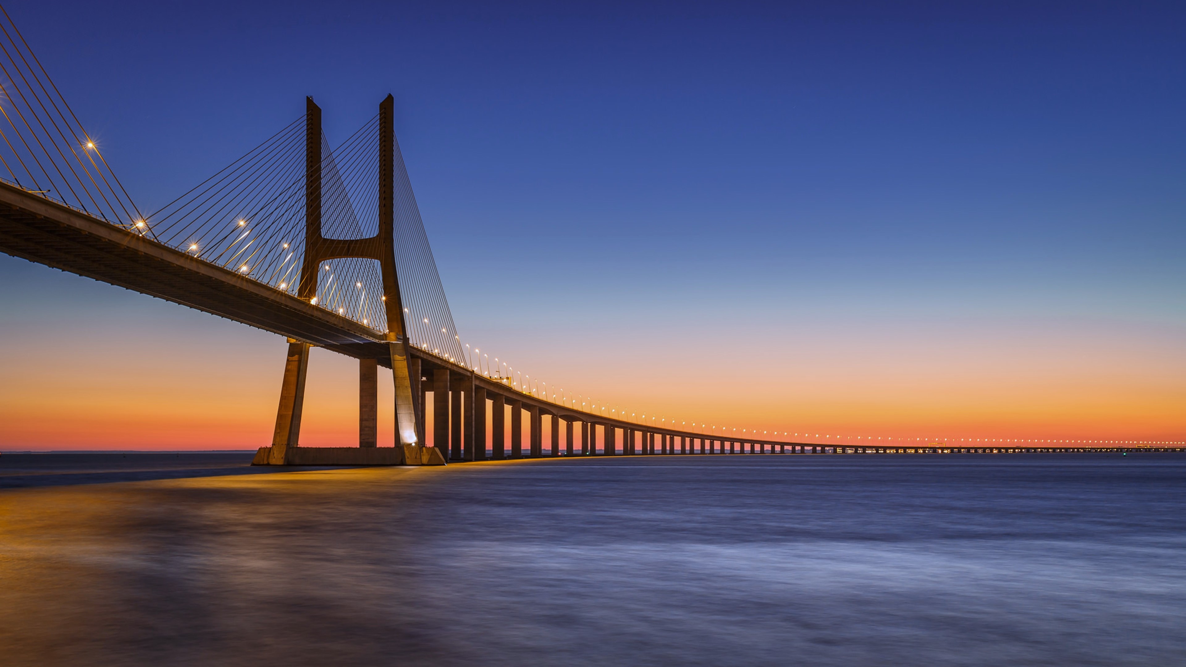 Vasco da Gama Bridge at sunset HD Wallpaper