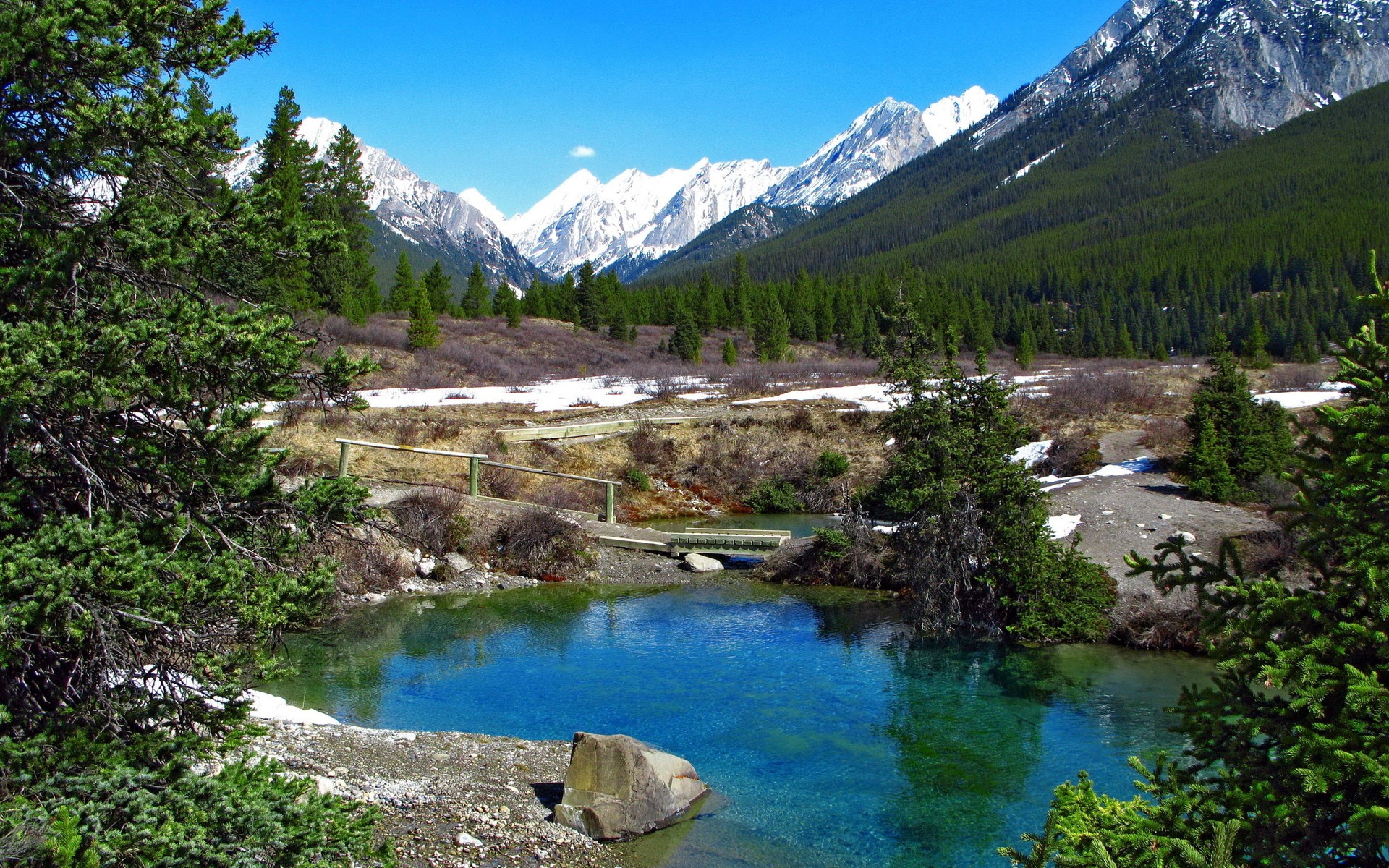 Mountain valley with a clear blue lake and pine trees HD Wallpaper