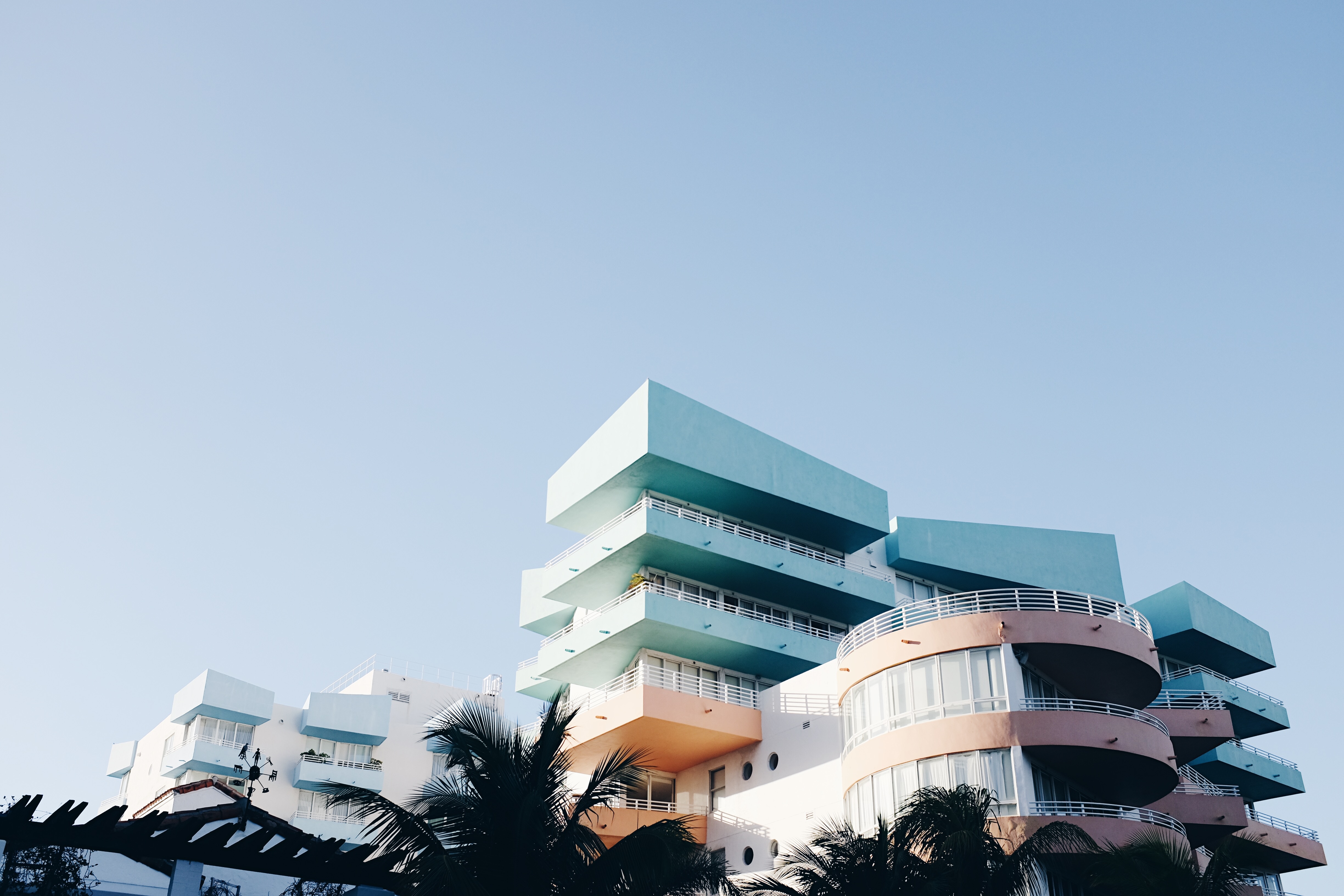 Pastel buildings with balconies in Miami under a clear sky HD Wallpaper