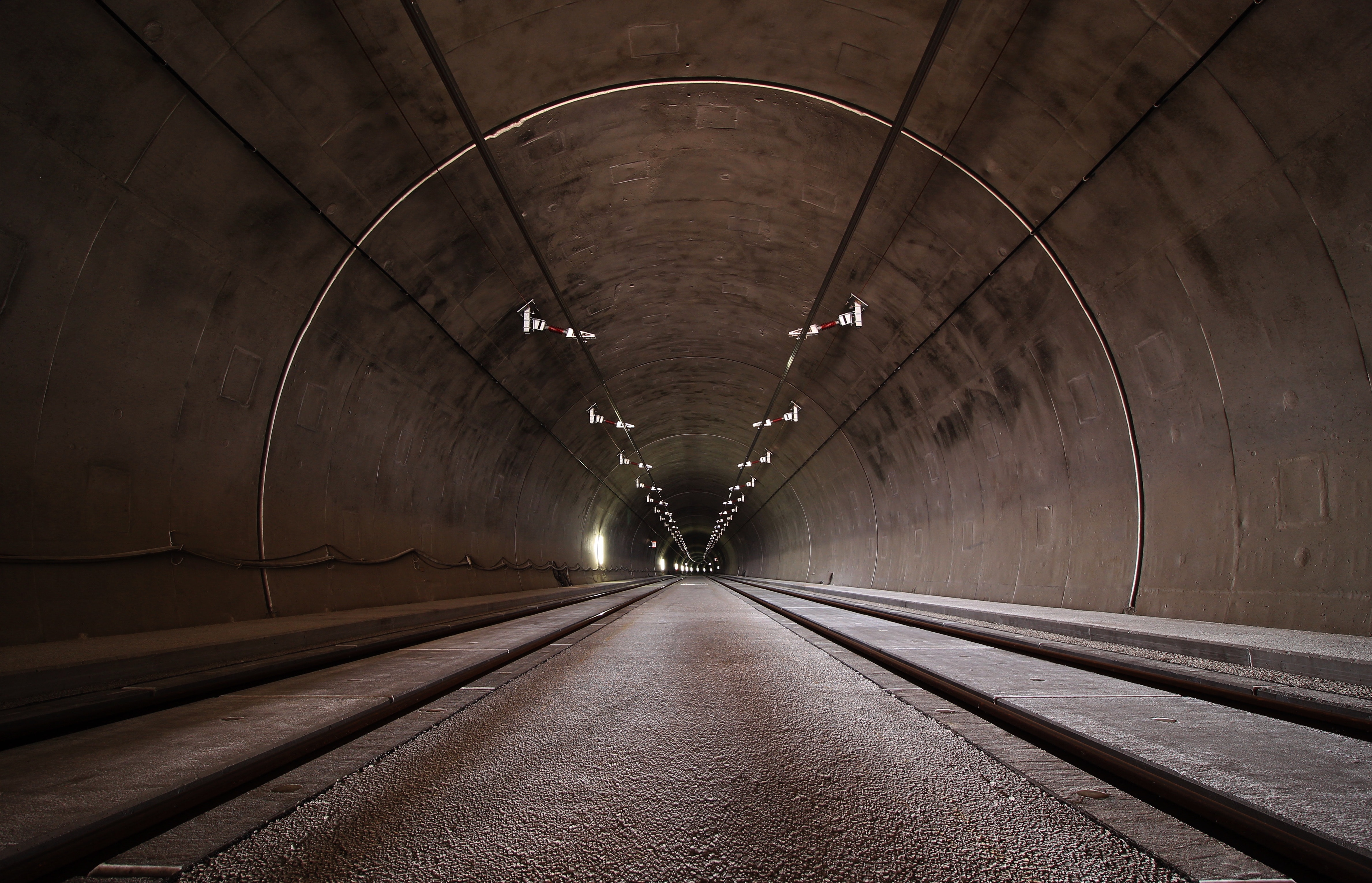 Tunnel with railway tracks and overhead lighting HD Wallpaper