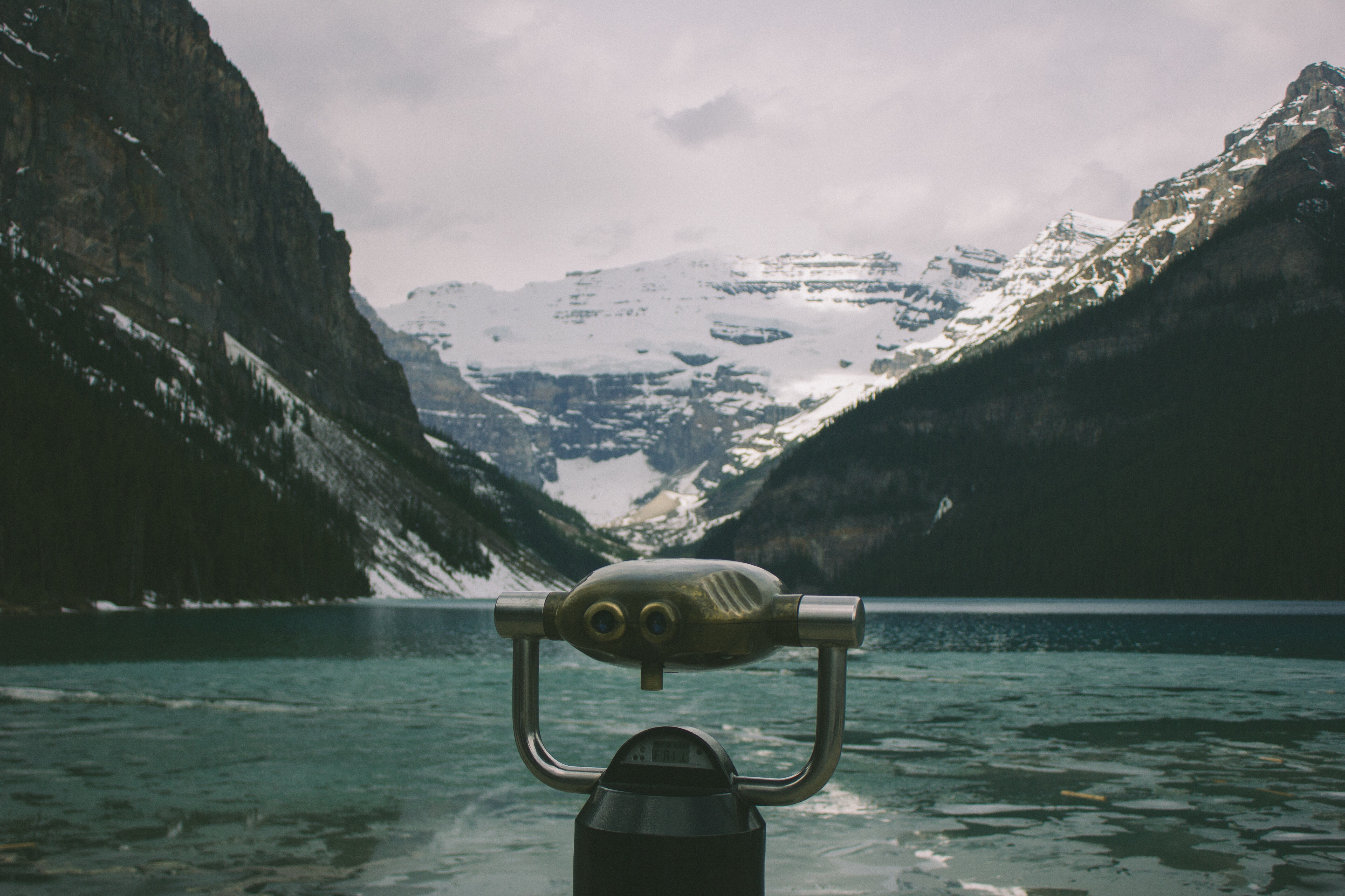Binocular overlooking a snowy mountain lake HD Wallpaper