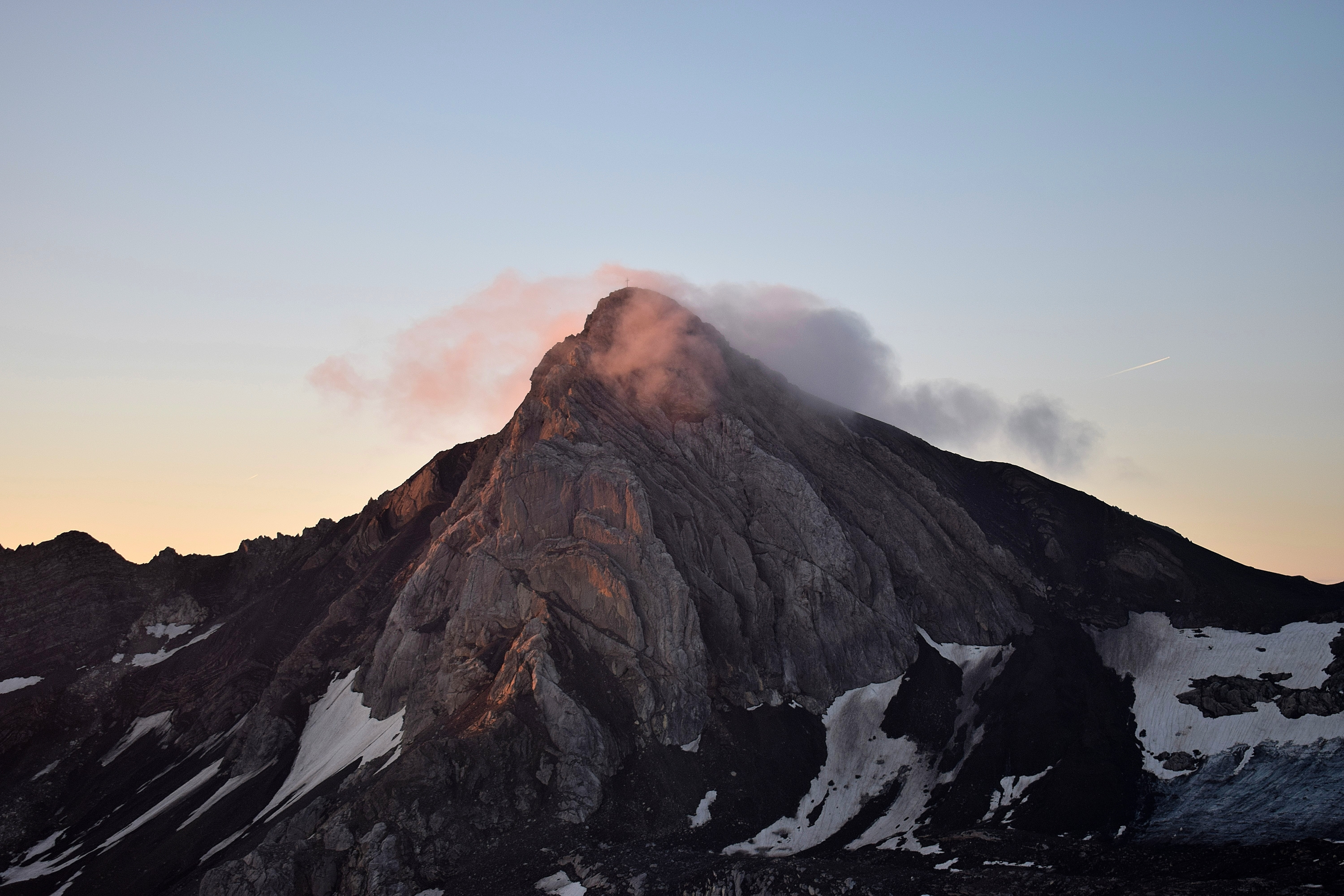 Mountain peak at sunrise with clouds and snow HD Wallpaper