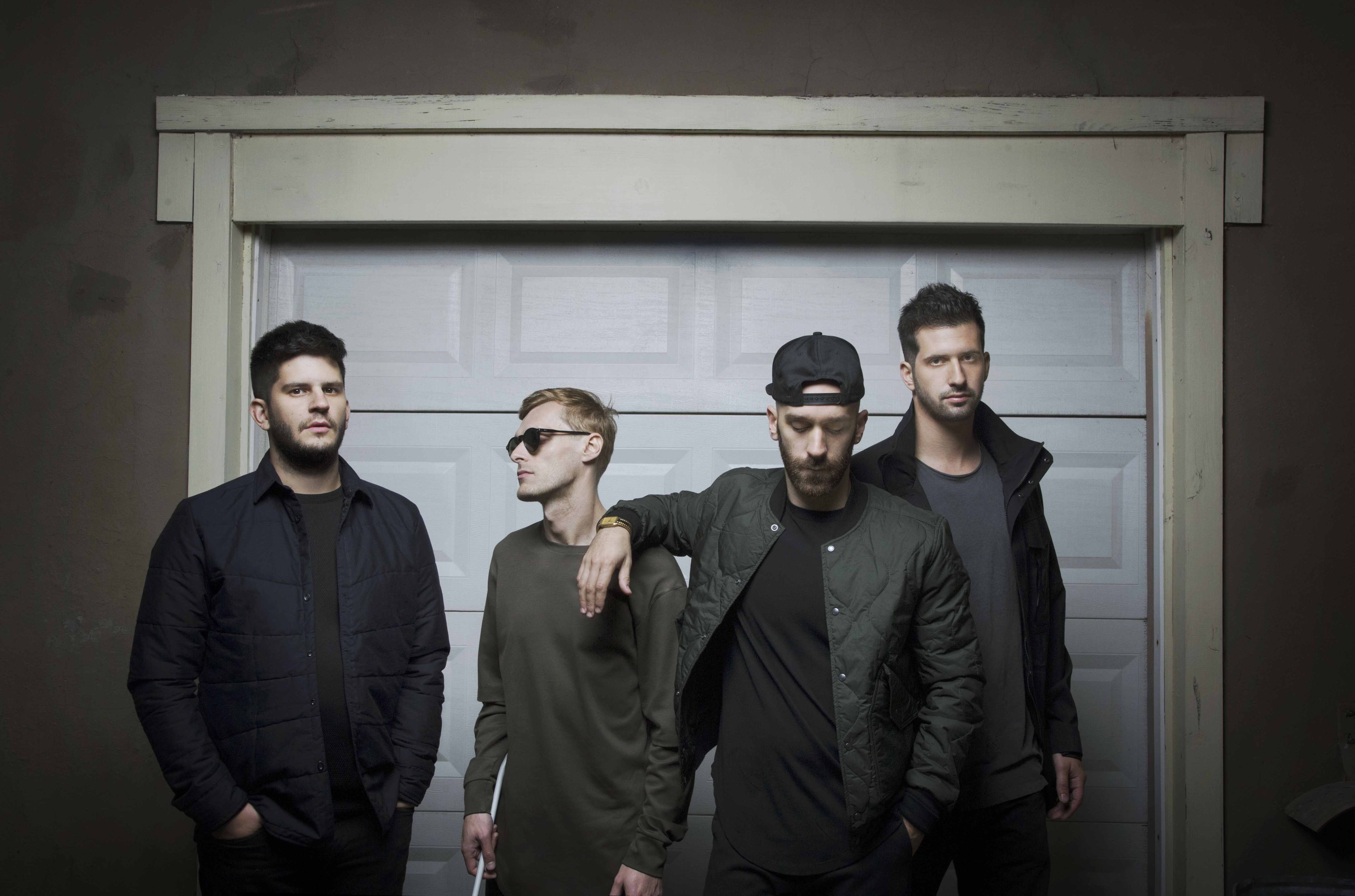 X Ambassadors band members in front of garage door HD Wallpaper