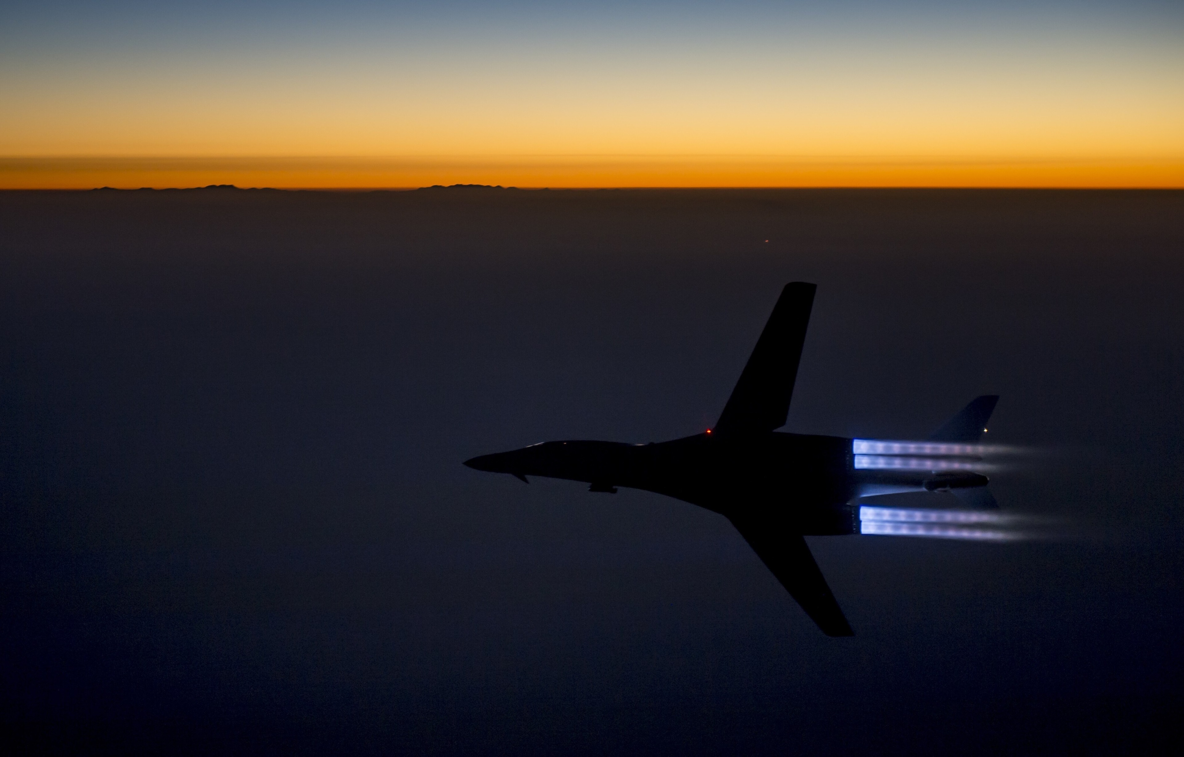 B-1 bomber flying at sunset HD Wallpaper