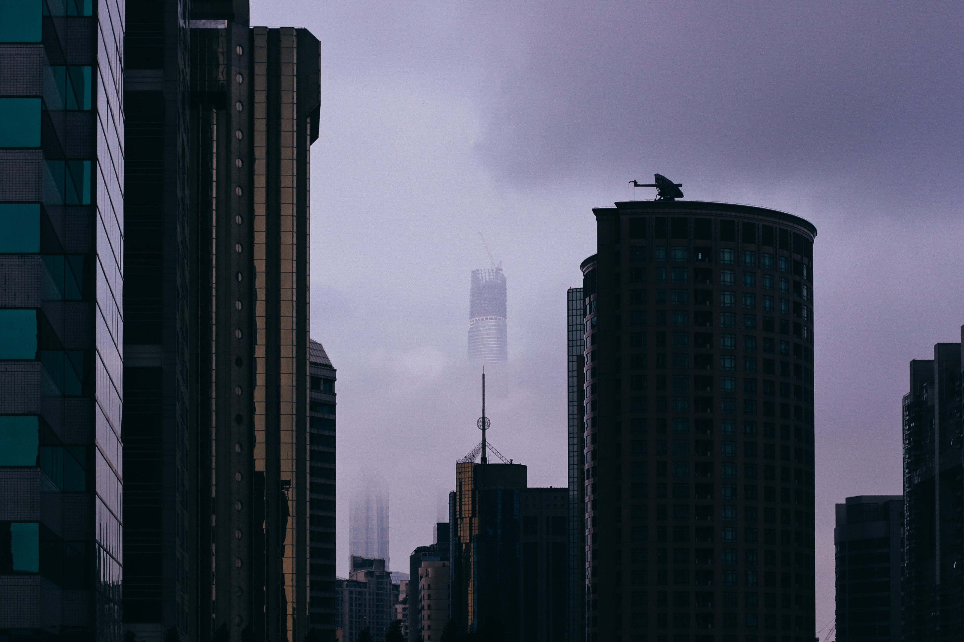 Cityscape with skyscrapers shrouded in fog HD Wallpaper