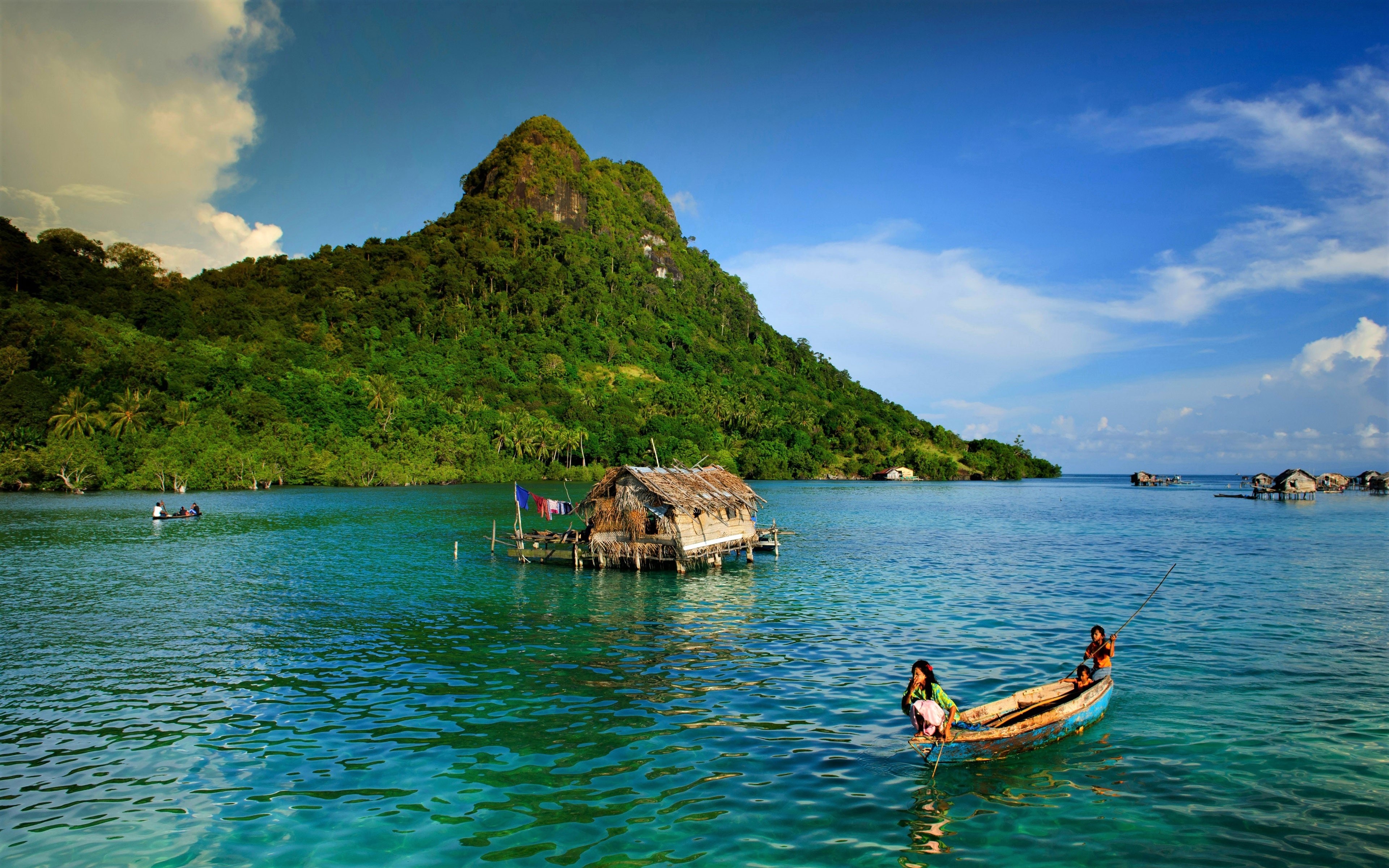 4K Ocean Scene with Mountain and Traditional Boat HD Wallpaper