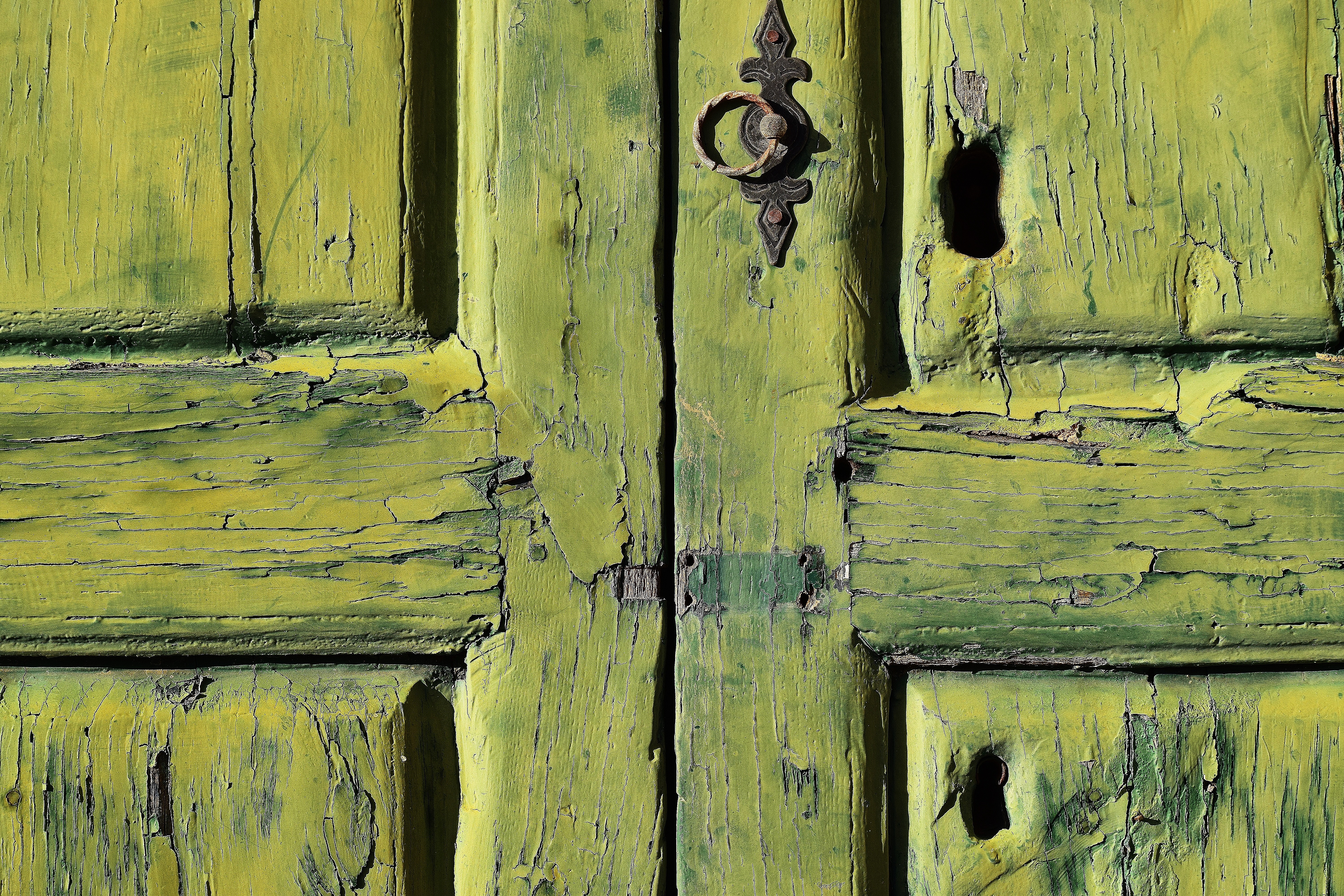 Old green wooden door with peeling paint and ornate handle HD Wallpaper