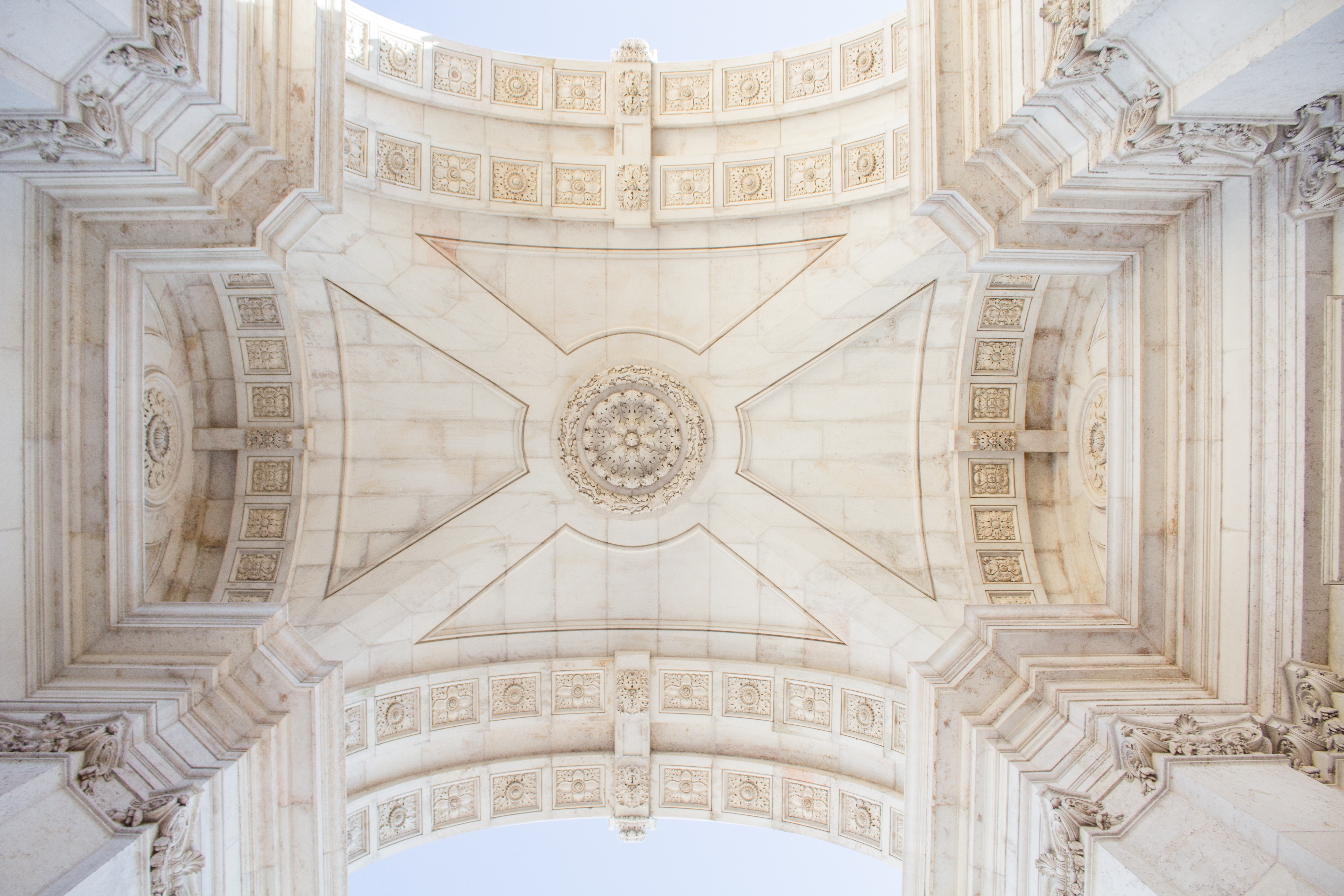 Ornate stone arch ceiling with intricate carvings HD Wallpaper