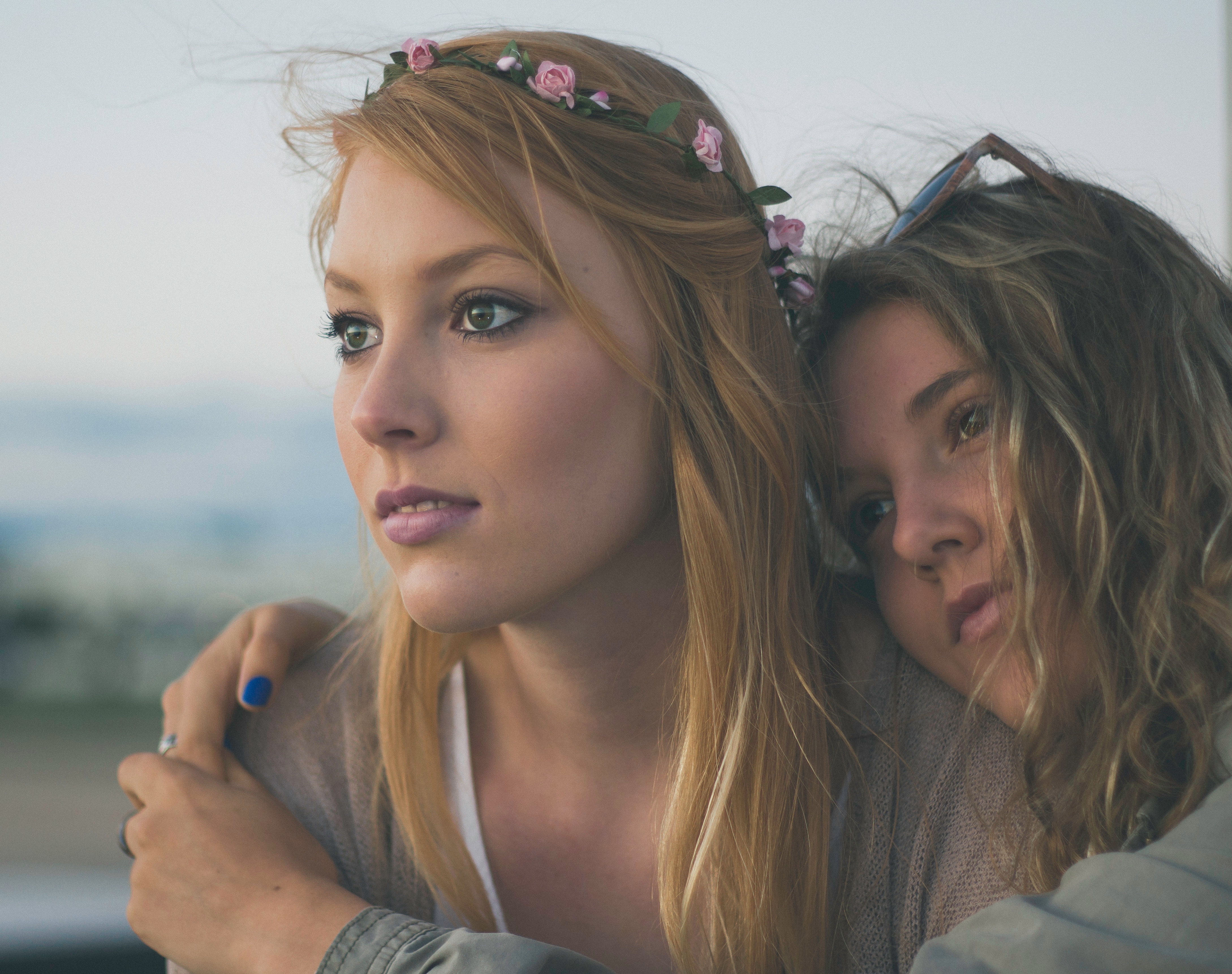 Two young women with a flower headband HD Wallpaper
