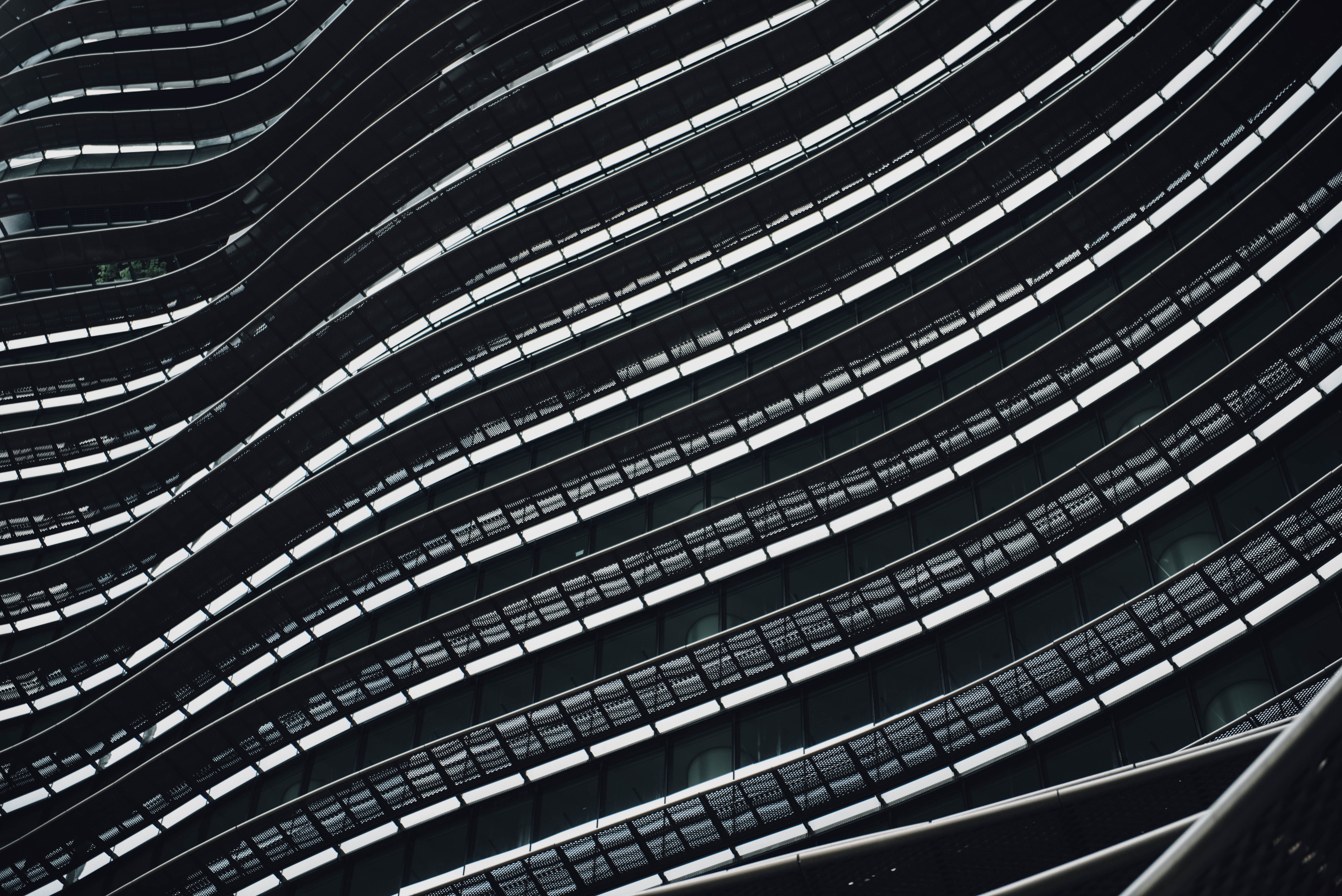 Abstract architectural facade with curved lines and windows HD Wallpaper
