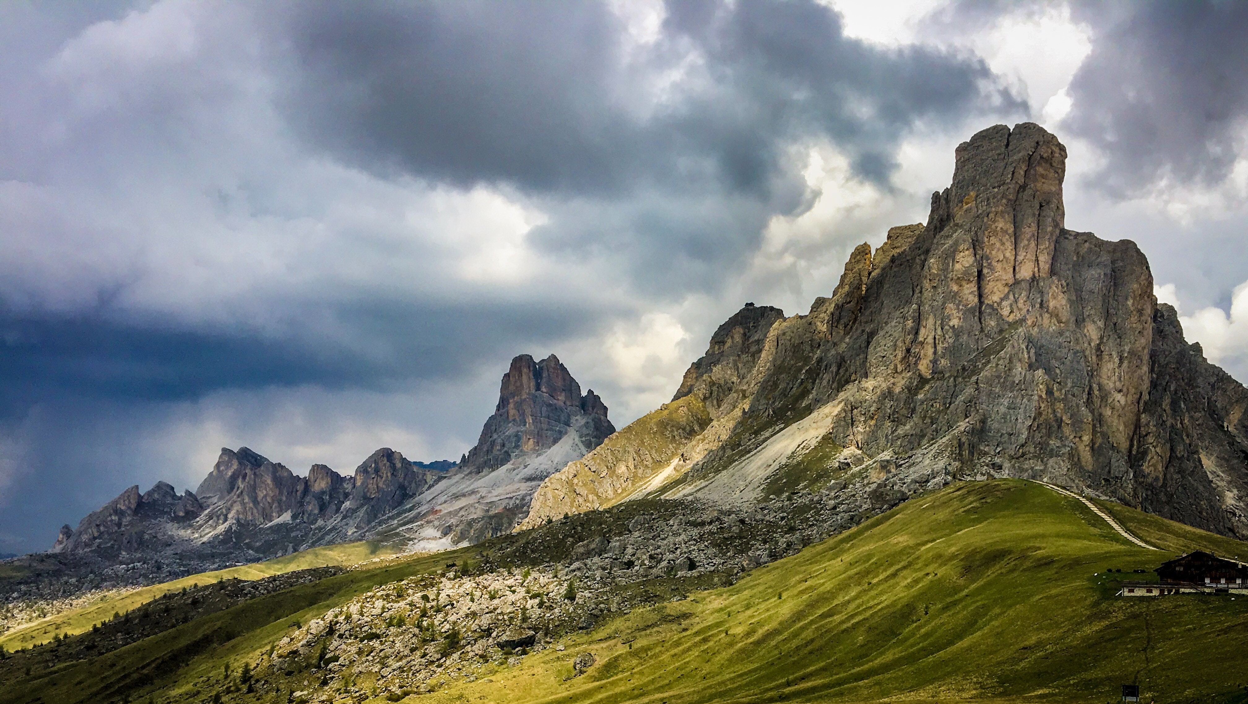 Mountain range with dramatic clouds in South Tyrol HD Wallpaper