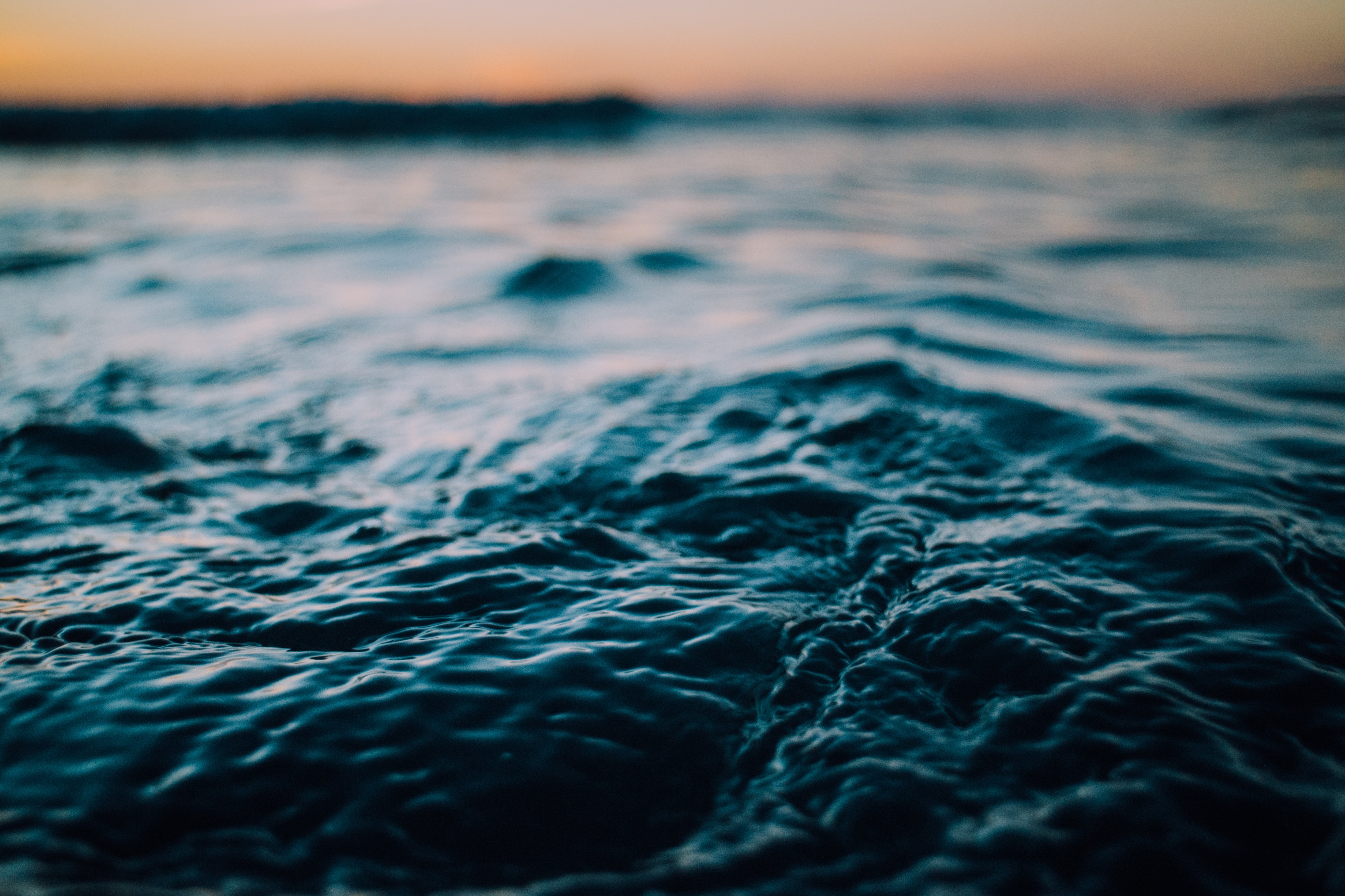Close-up of ocean waves at sunset HD Wallpaper
