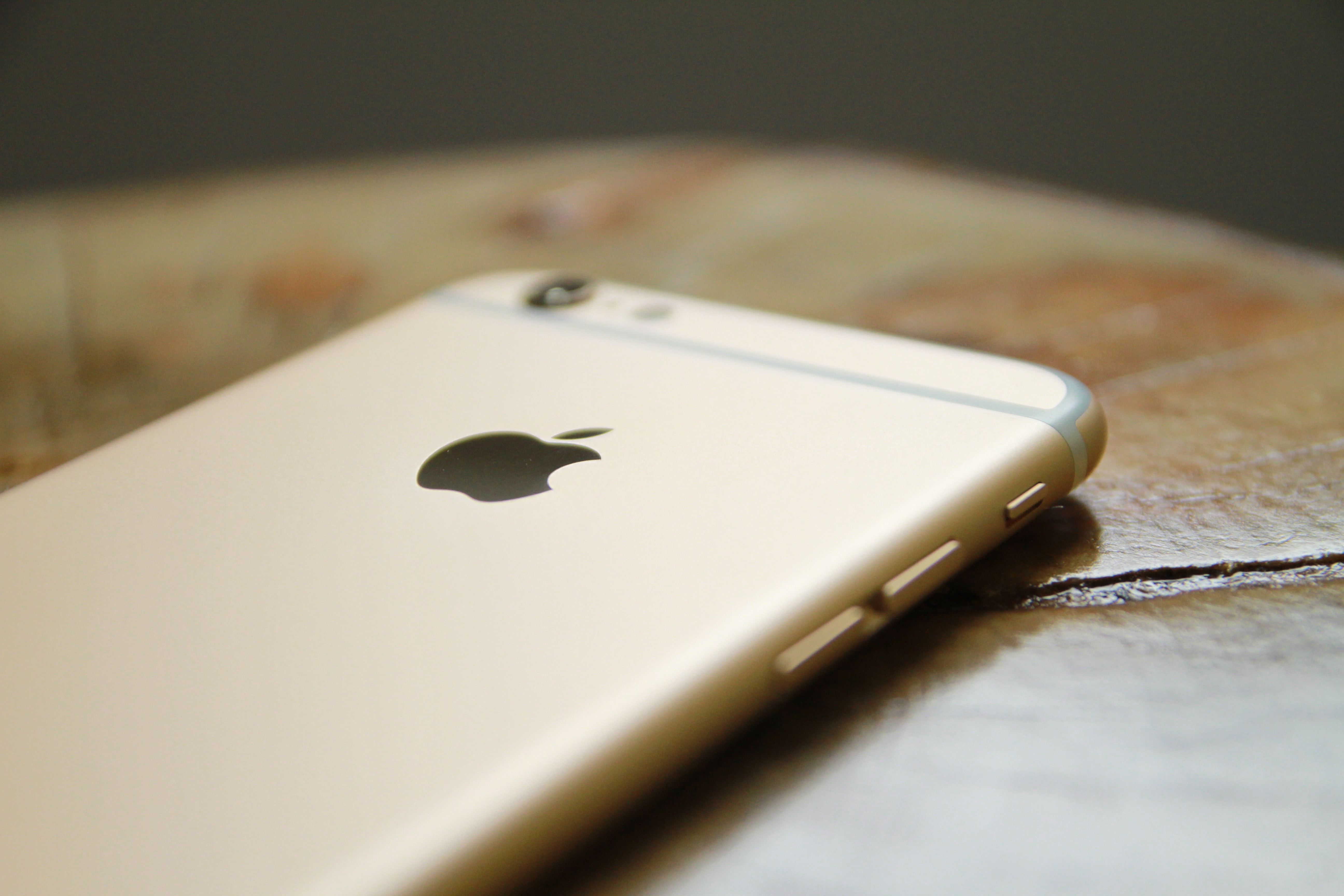Gold iPhone 6 on a wooden table HD Wallpaper