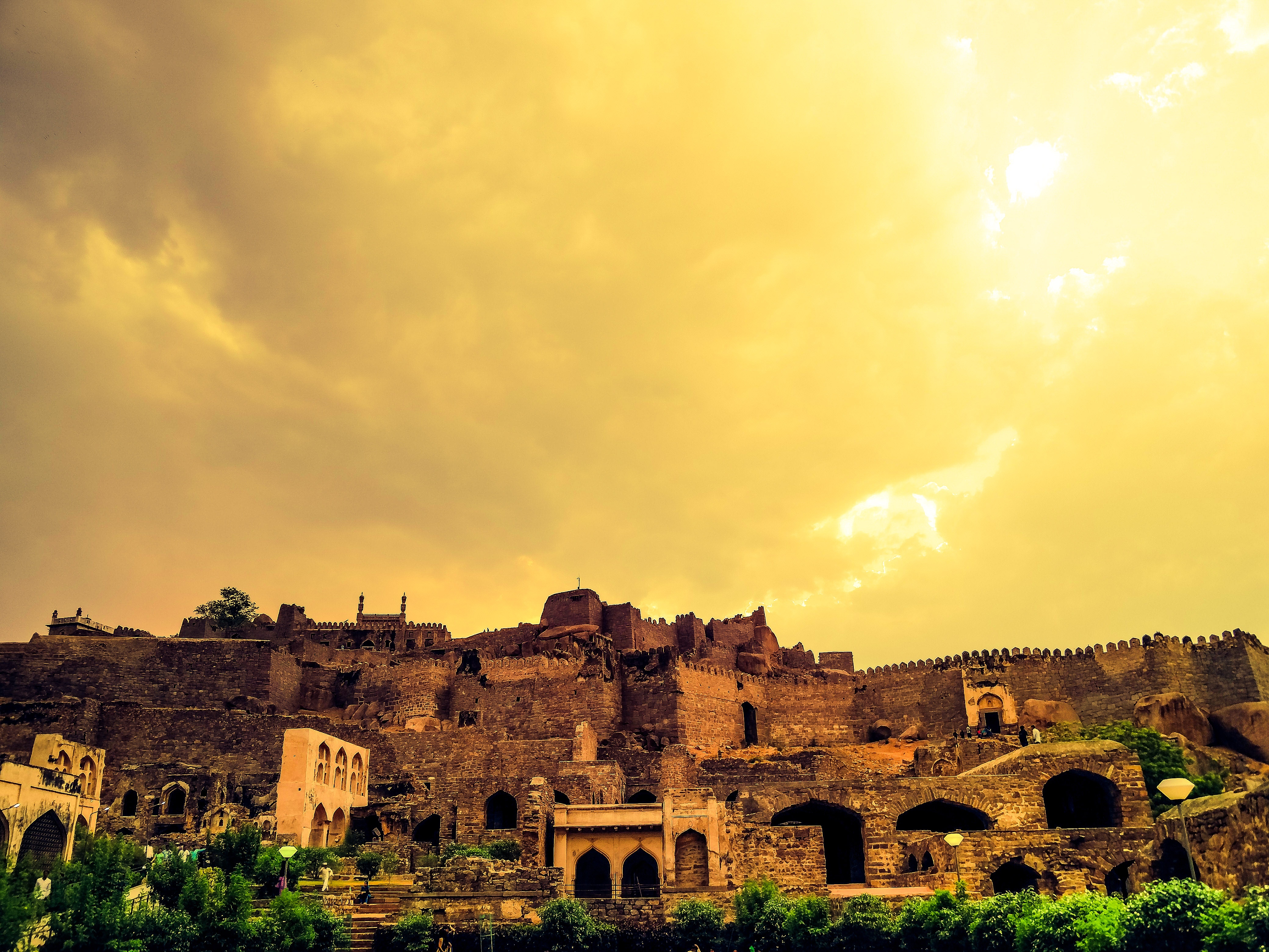 Golconda Fort in Hyderabad under a cloudy sky HD Wallpaper