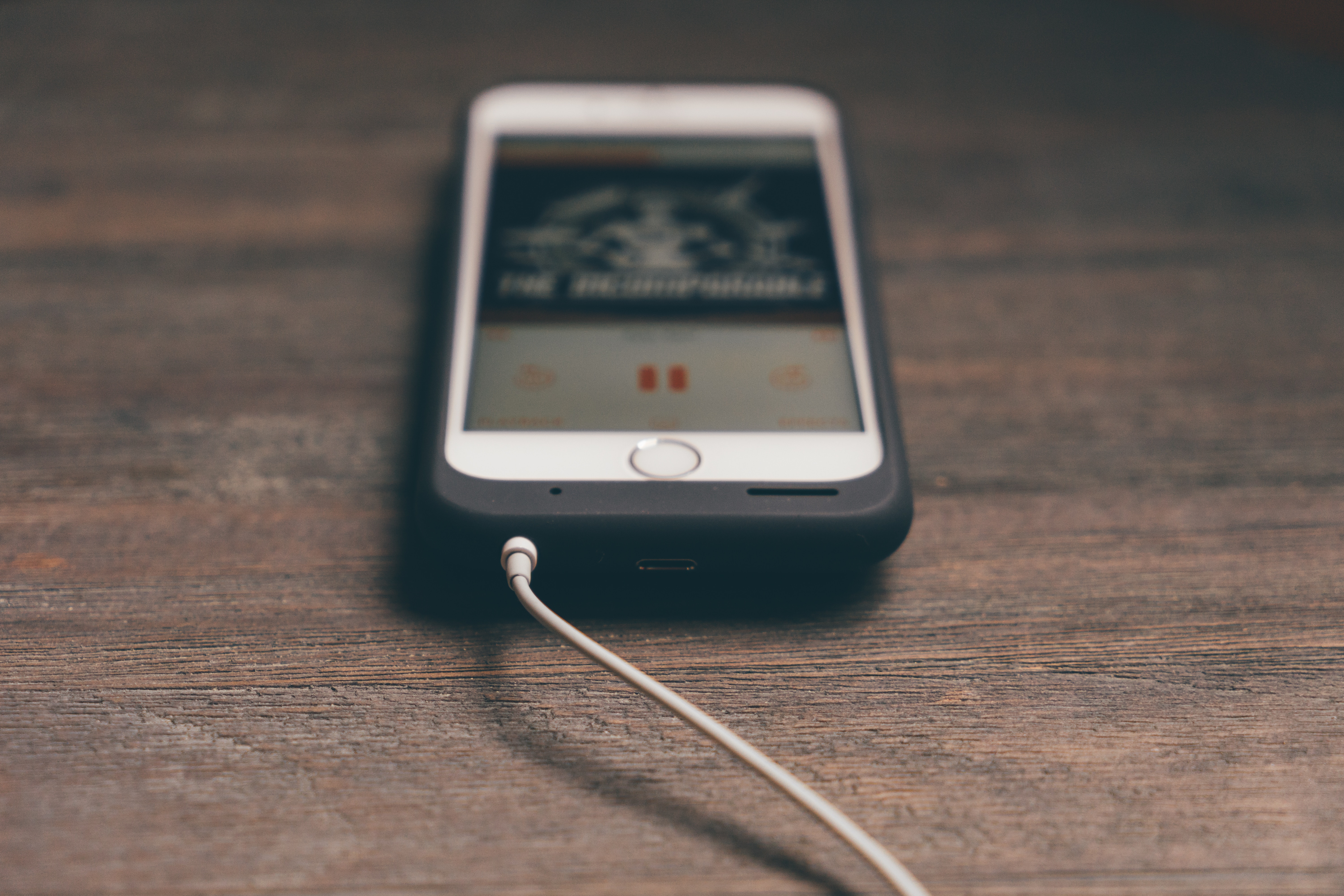 iPhone with Smart Battery Case playing music HD Wallpaper