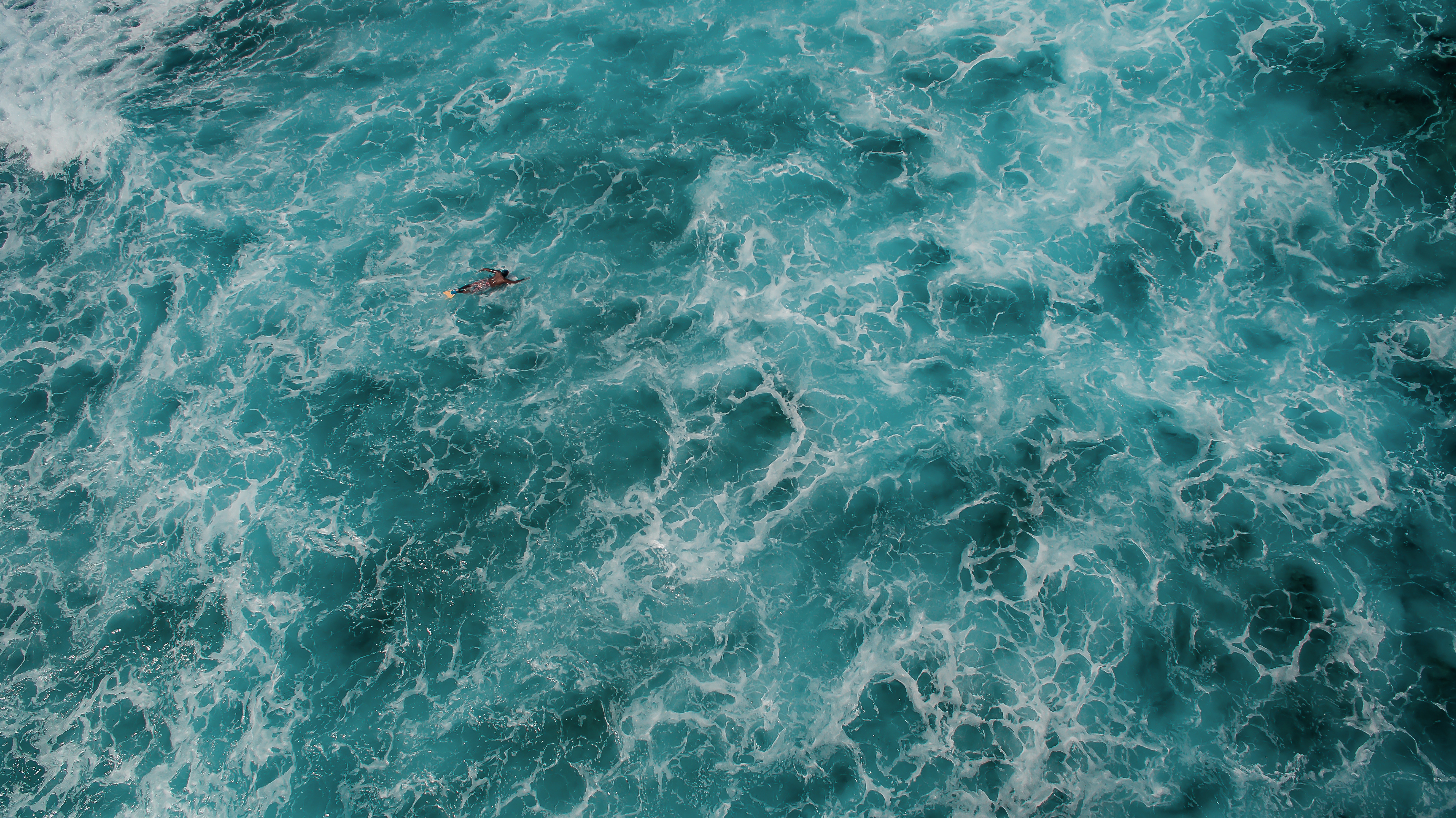 Aerial View of Surfer in Turquoise Ocean Waves HD Wallpaper