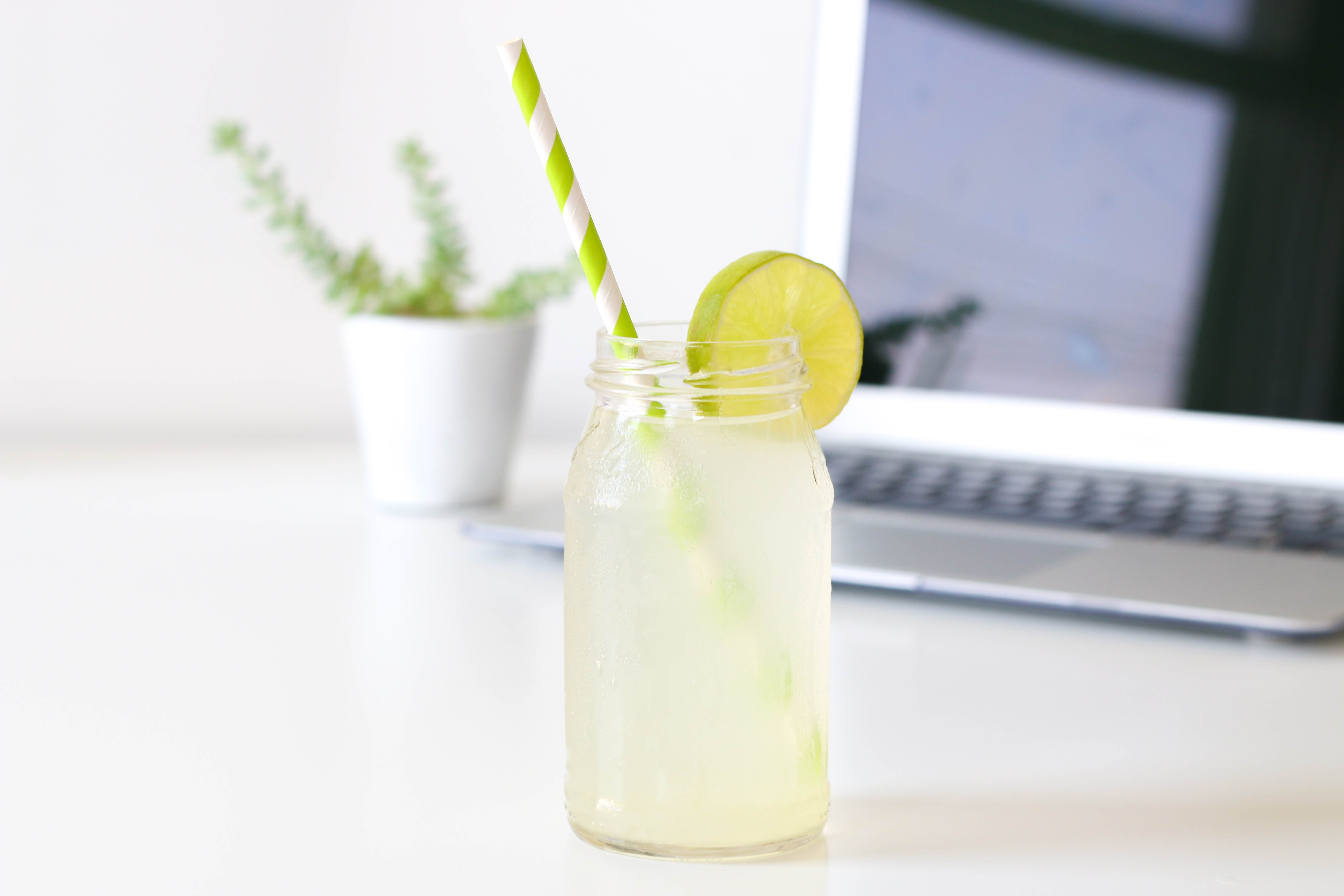 Lemonade in a jar with a lime slice and straw HD Wallpaper