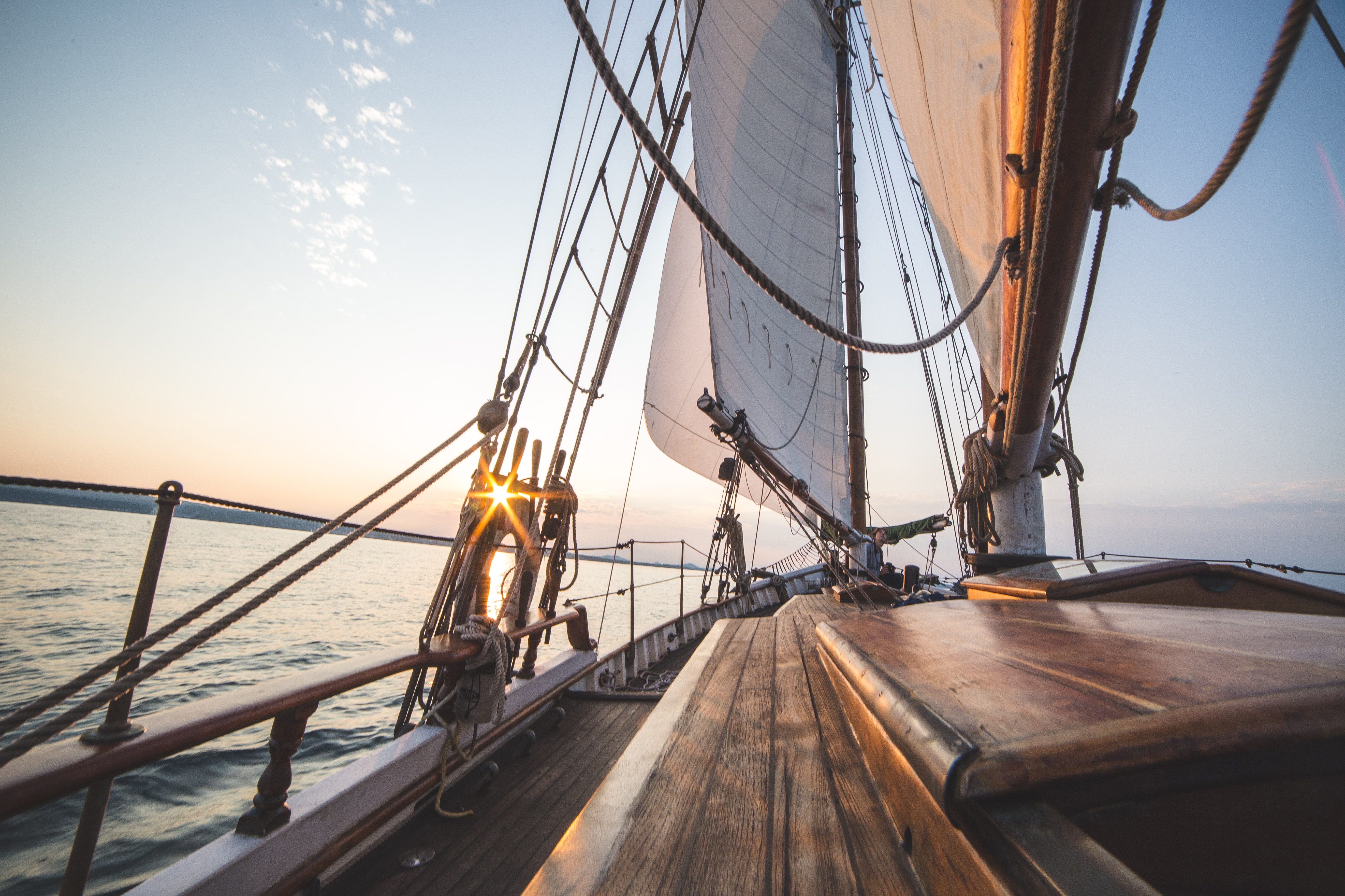 Sailboat sailing on the water at sunset HD Wallpaper