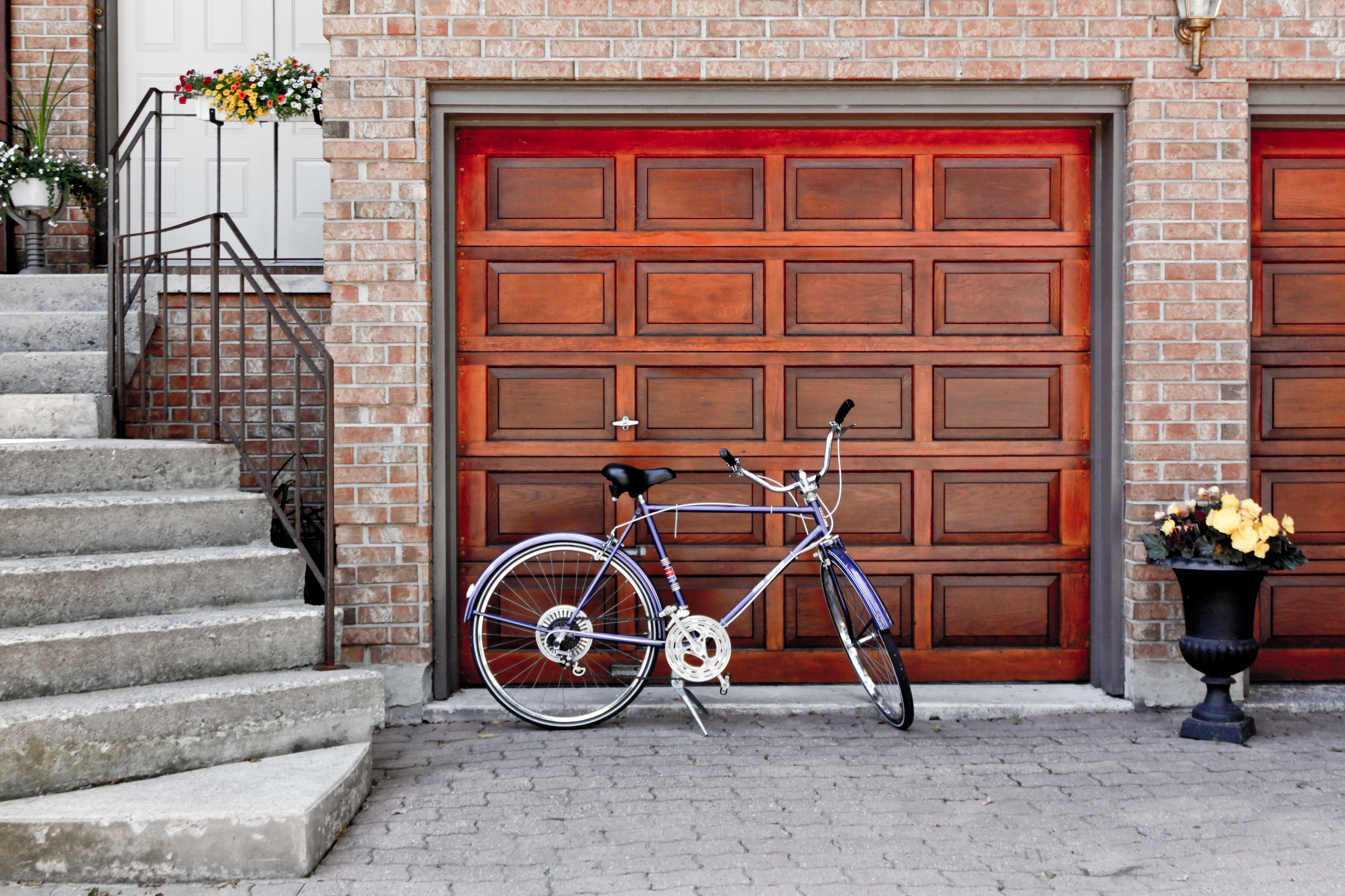 Purple bicycle parked in front of a wooden garage door HD Wallpaper