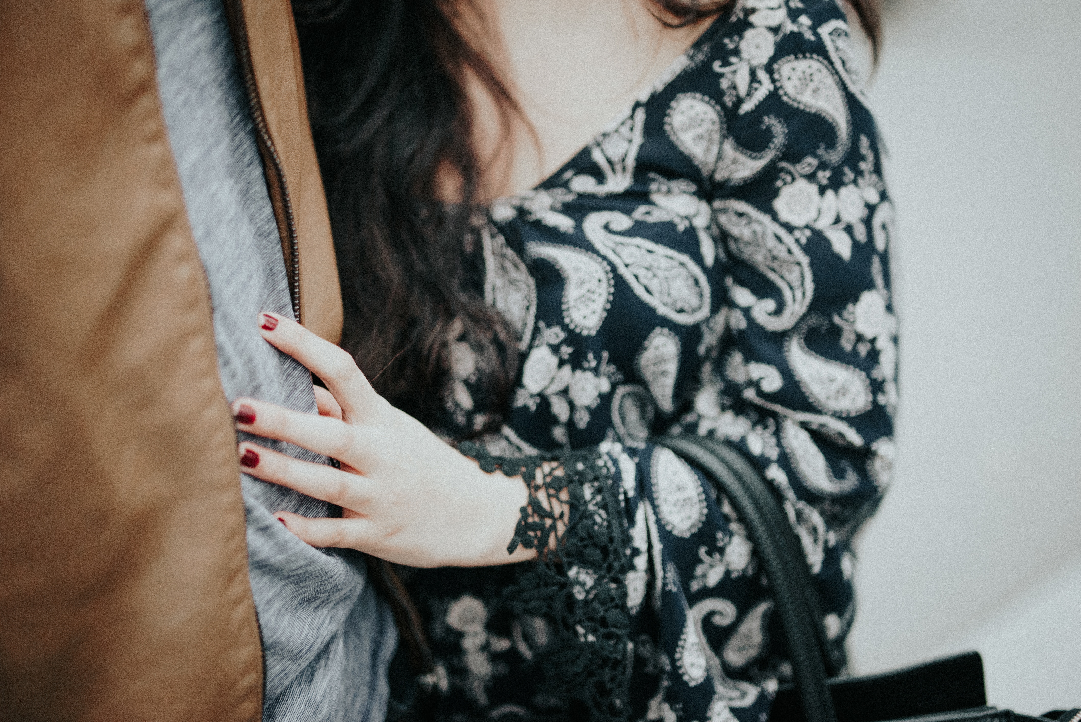Woman in paisley dress and brown jacket HD Wallpaper