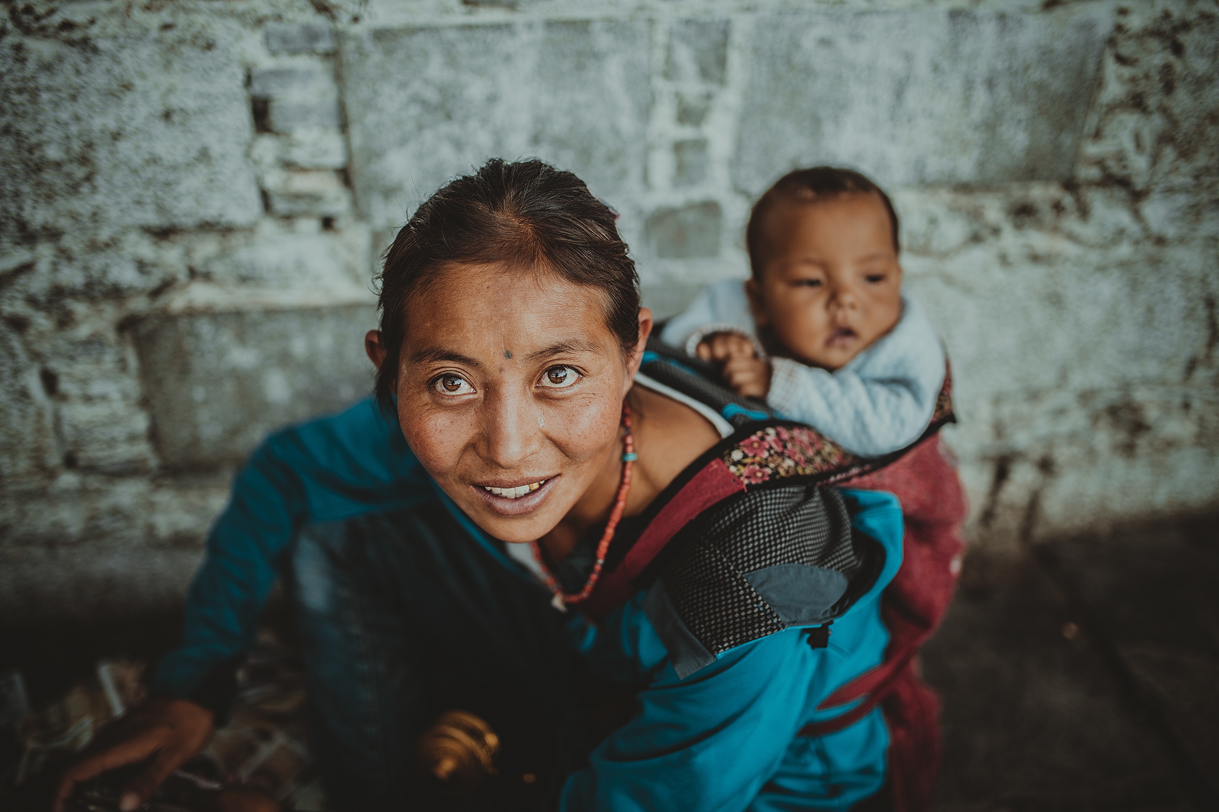 Woman carrying a baby on her back HD Wallpaper
