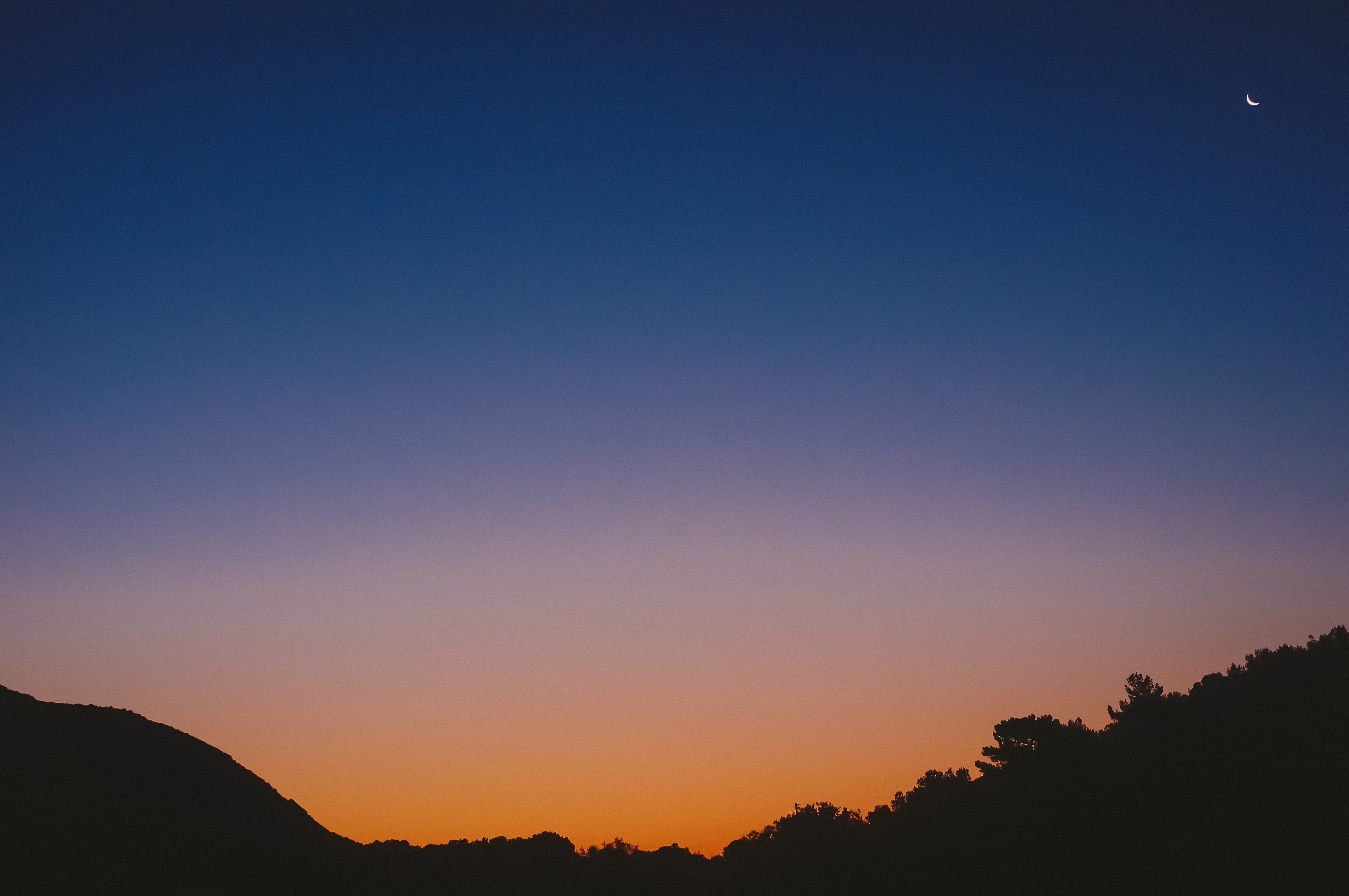 Crescent Moon Over Silhouetted Hills at Dusk HD Wallpaper