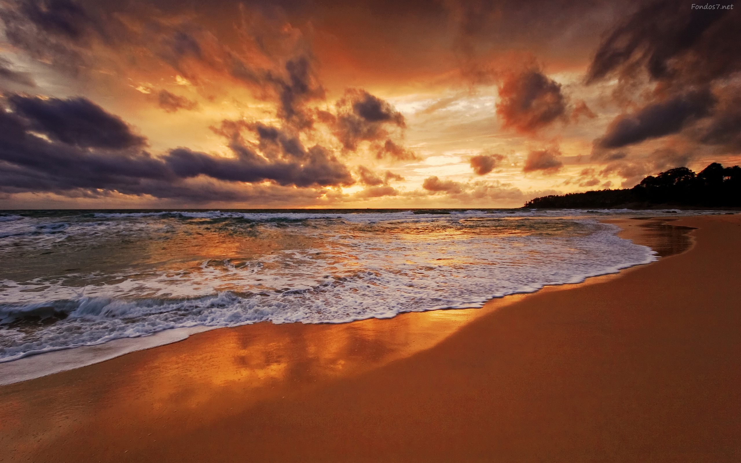 Sunset over a beach with waves HD Wallpaper