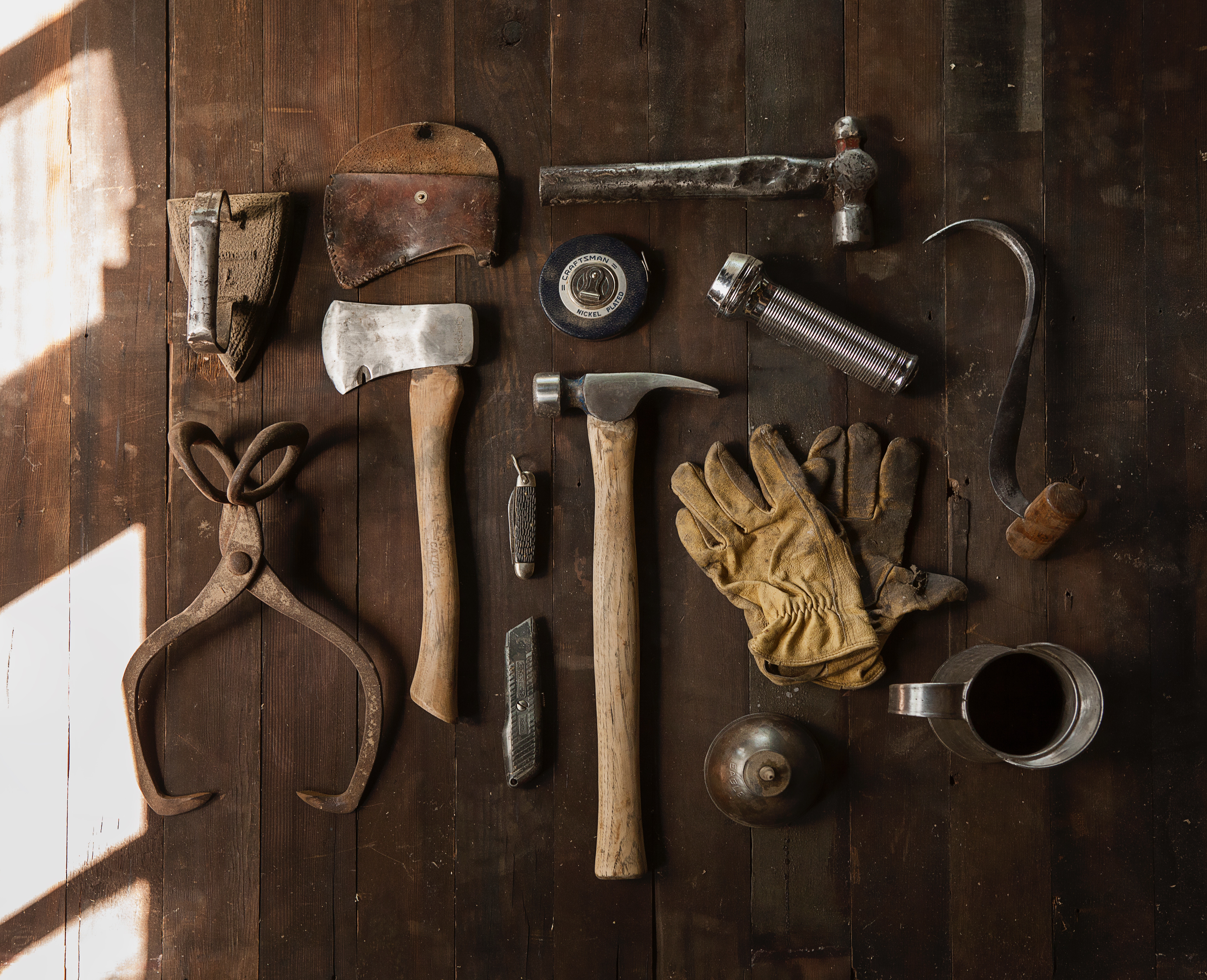 Collection of antique woodworking tools on a wooden surface HD Wallpaper