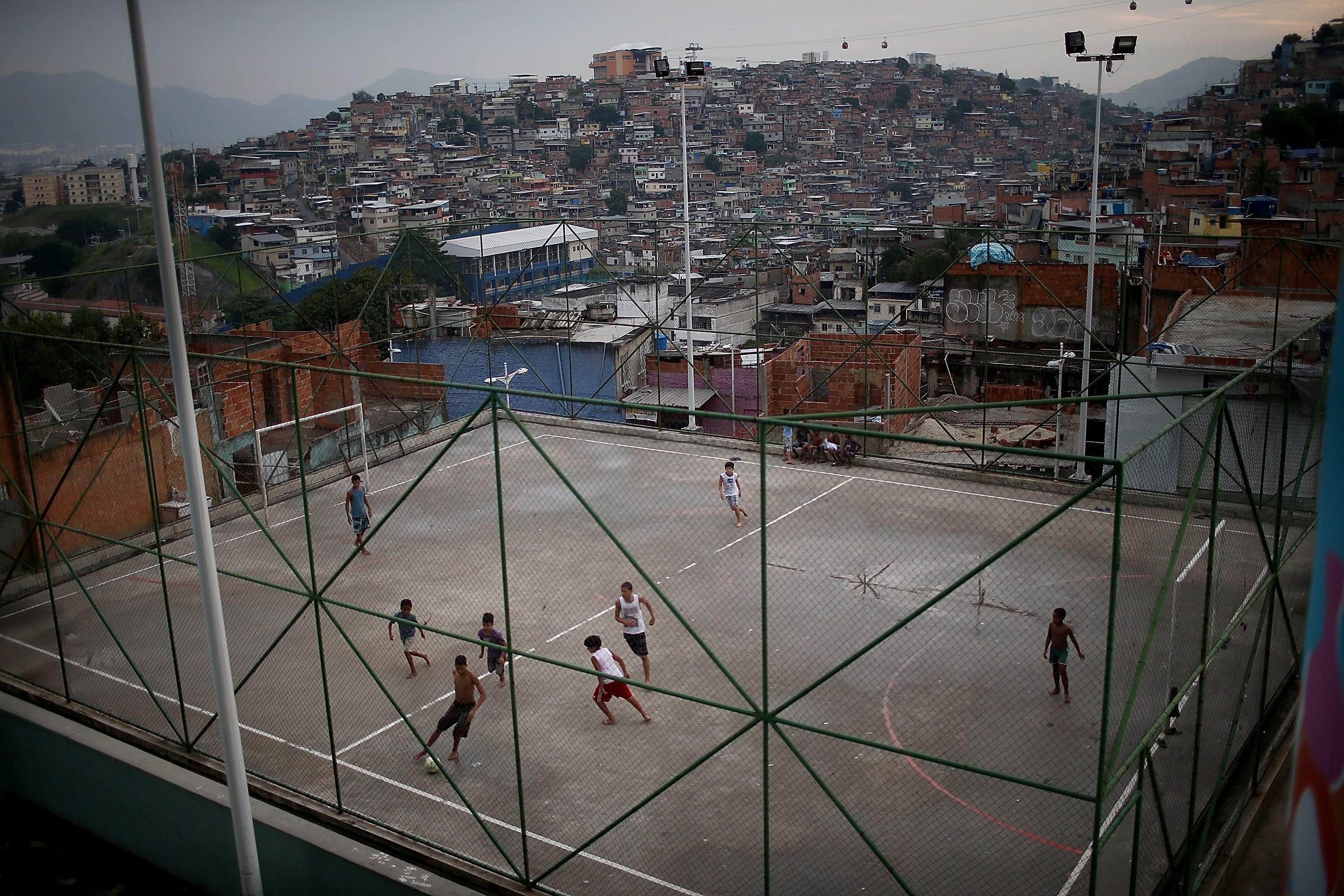 Children playing soccer in a favela, Rio de Janeiro HD Wallpaper