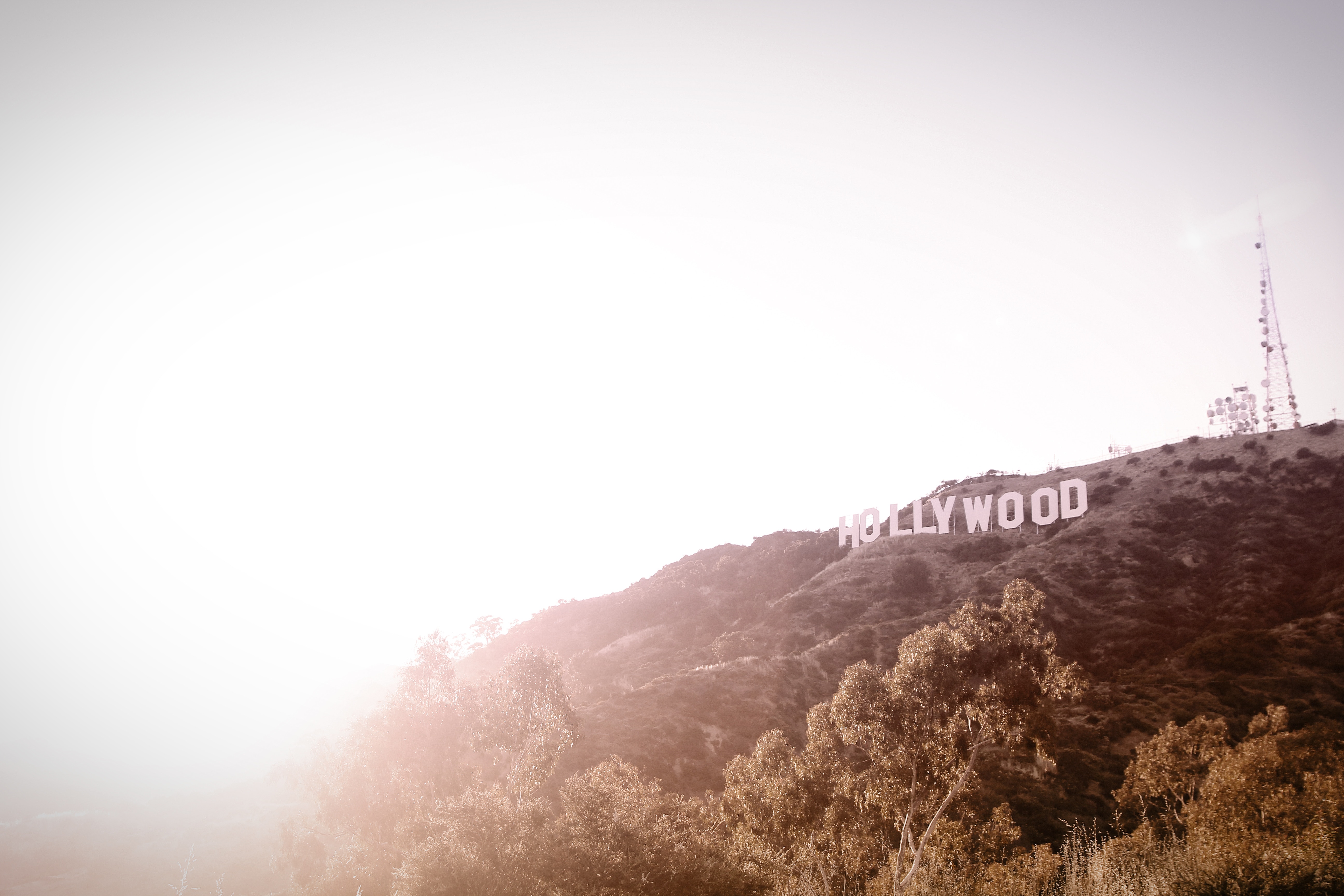 The Hollywood Sign on a Hill with a Radio Tower HD Wallpaper