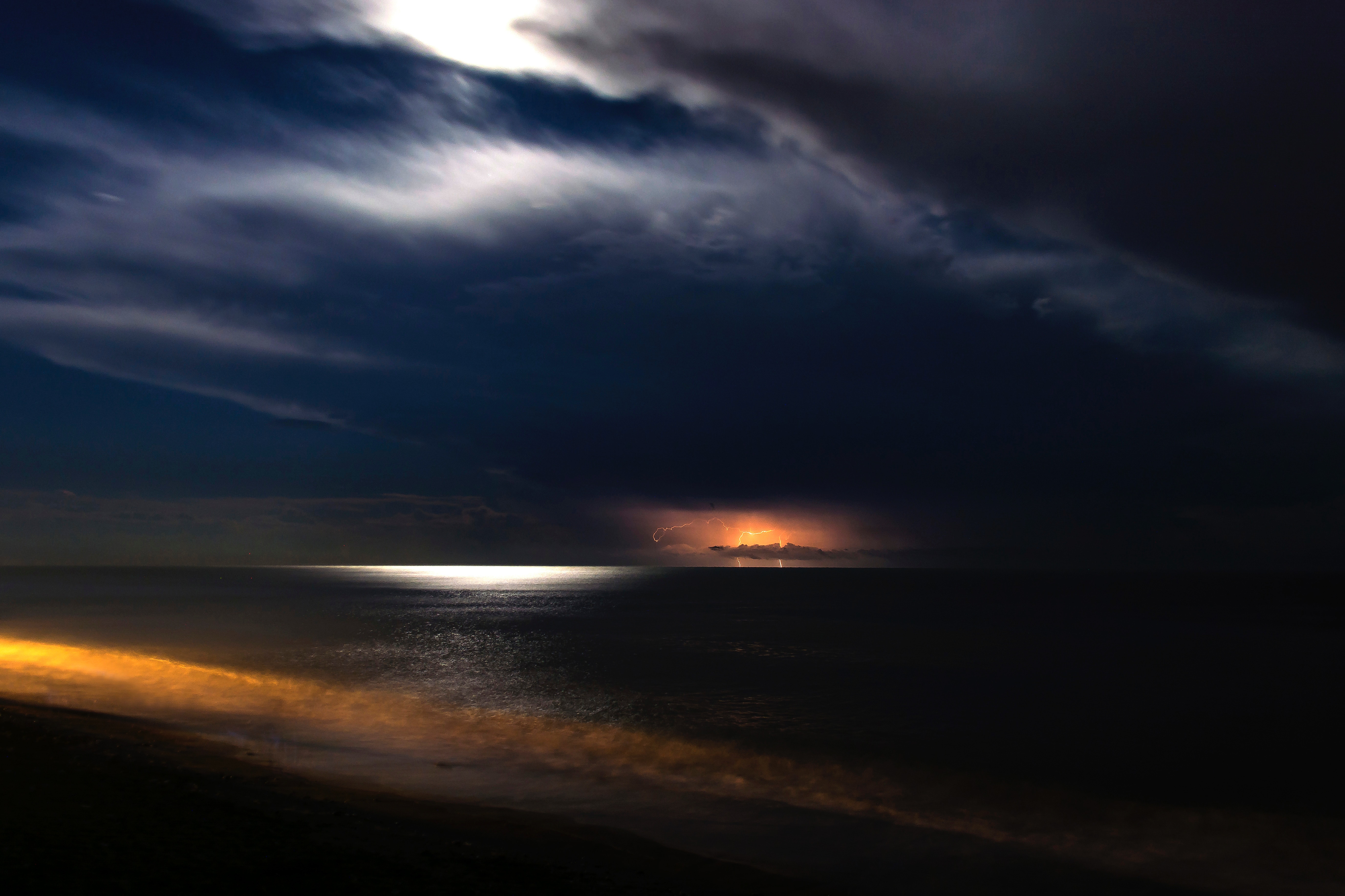 Lightning storm over the ocean at night with moon reflection HD Wallpaper