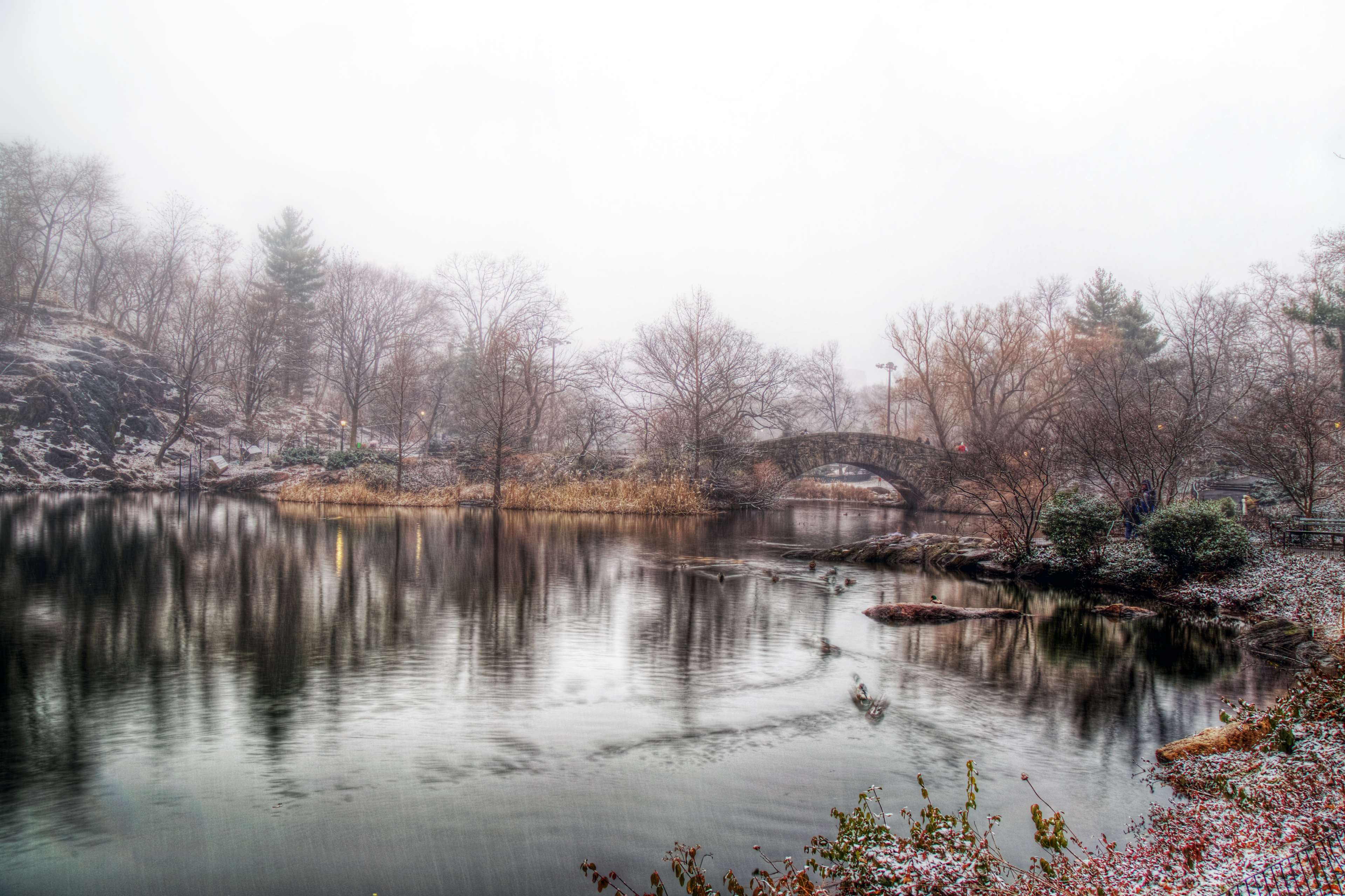 Stone bridge over a lake in Central Park, New York during winter HD Wallpaper
