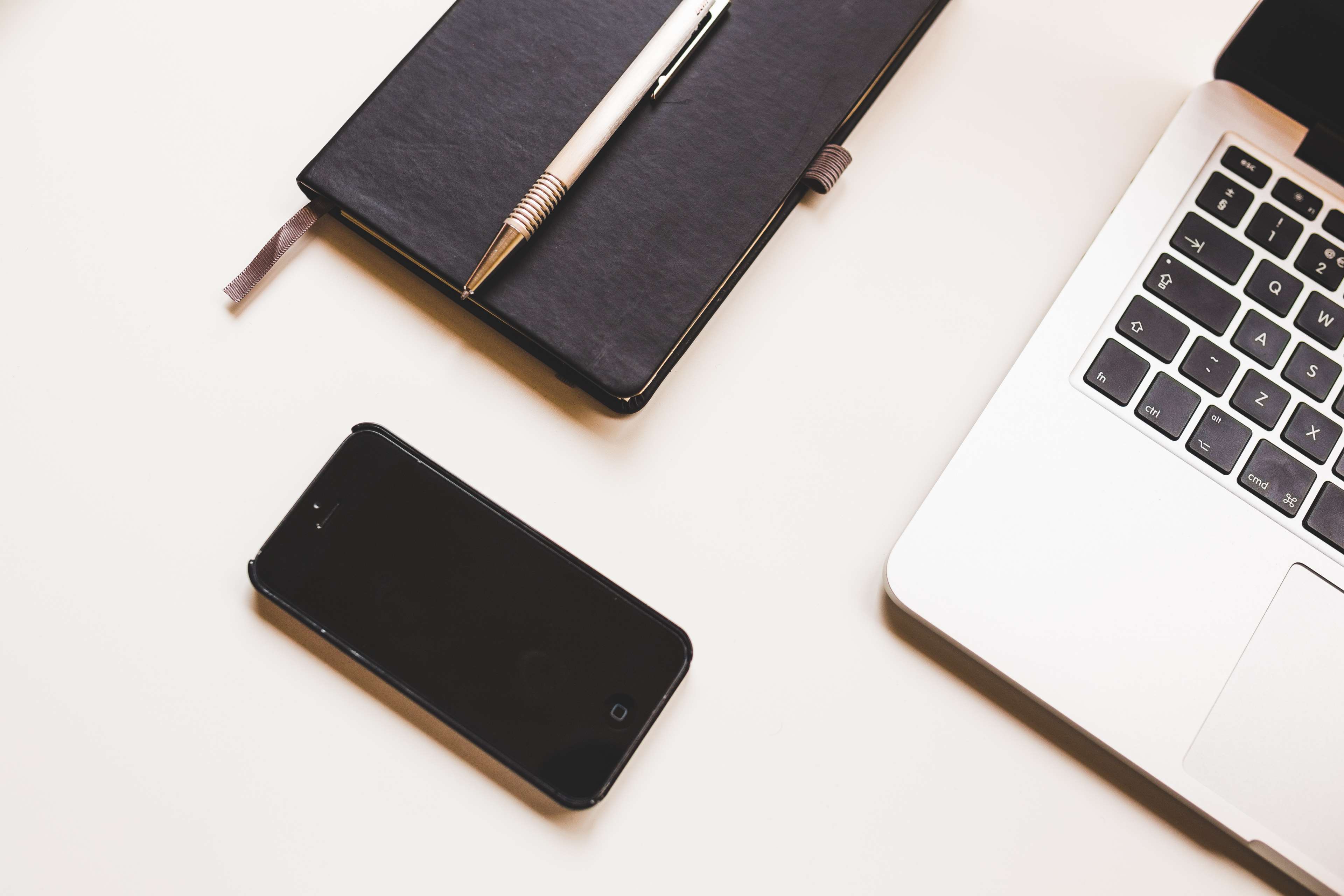 Apple MacBook, iPhone, Notebook, and Pen on Desk HD Wallpaper
