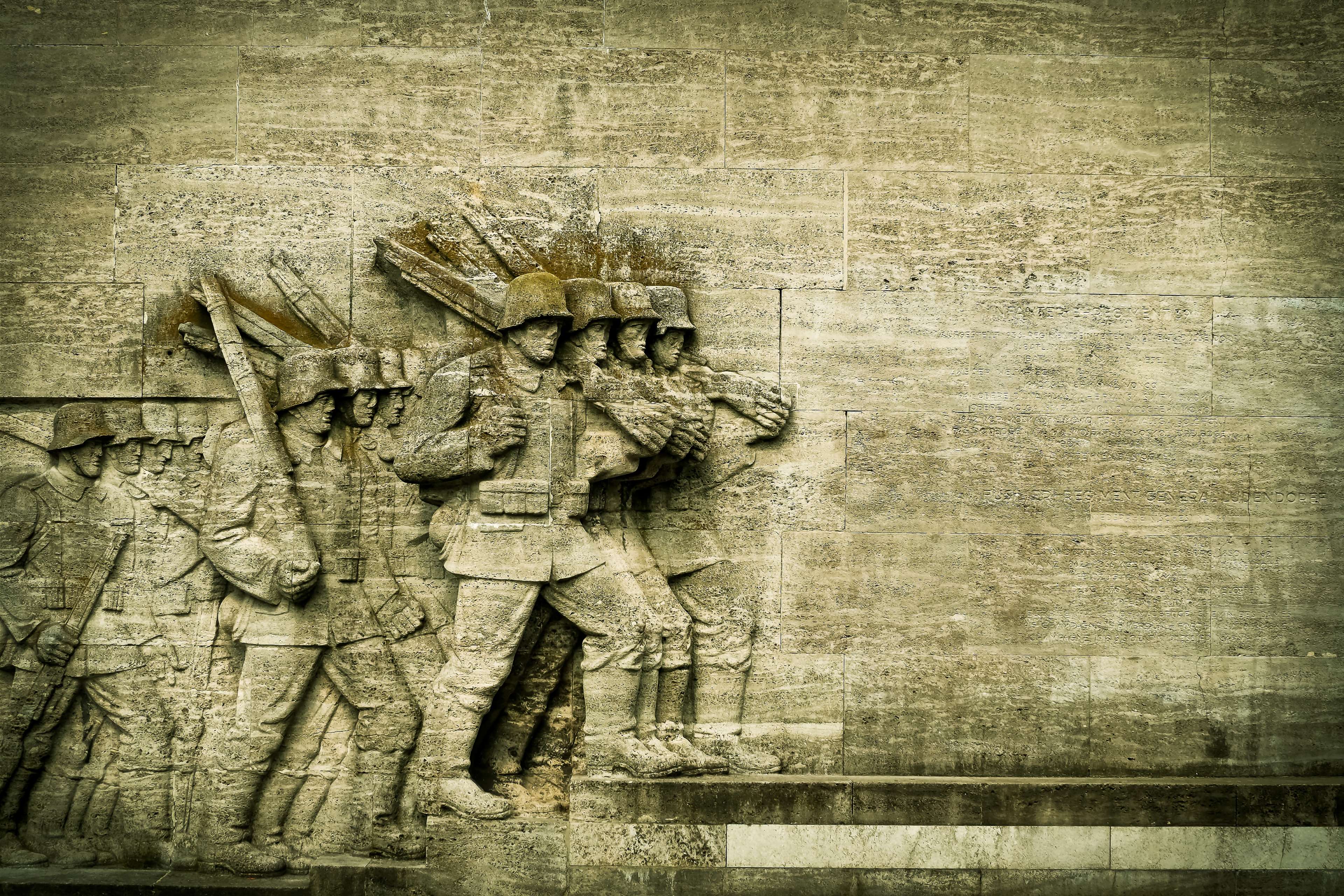 Soldiers marching in a stone relief sculpture HD Wallpaper
