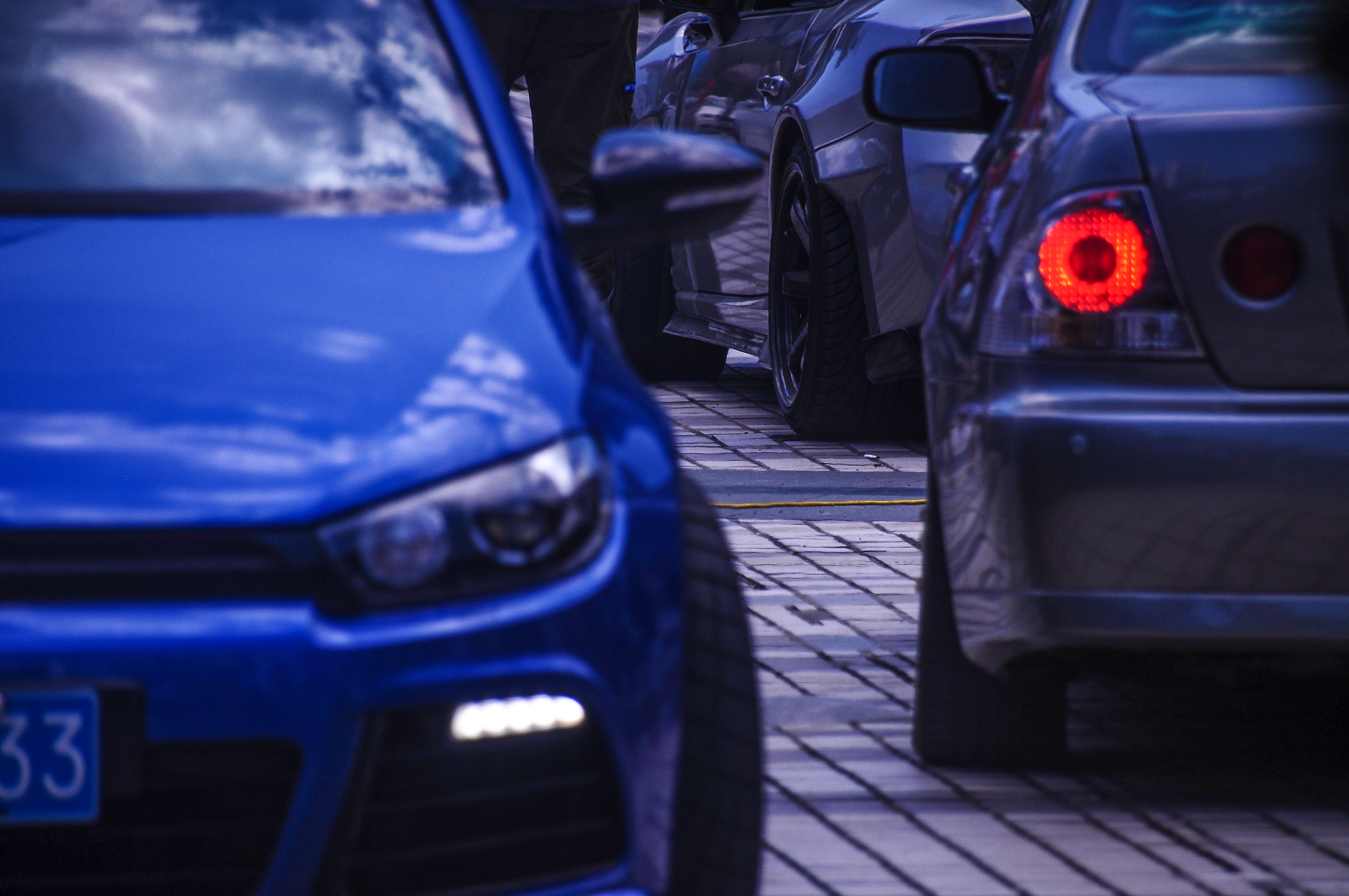 Blue car and other vehicles parked on a street HD Wallpaper