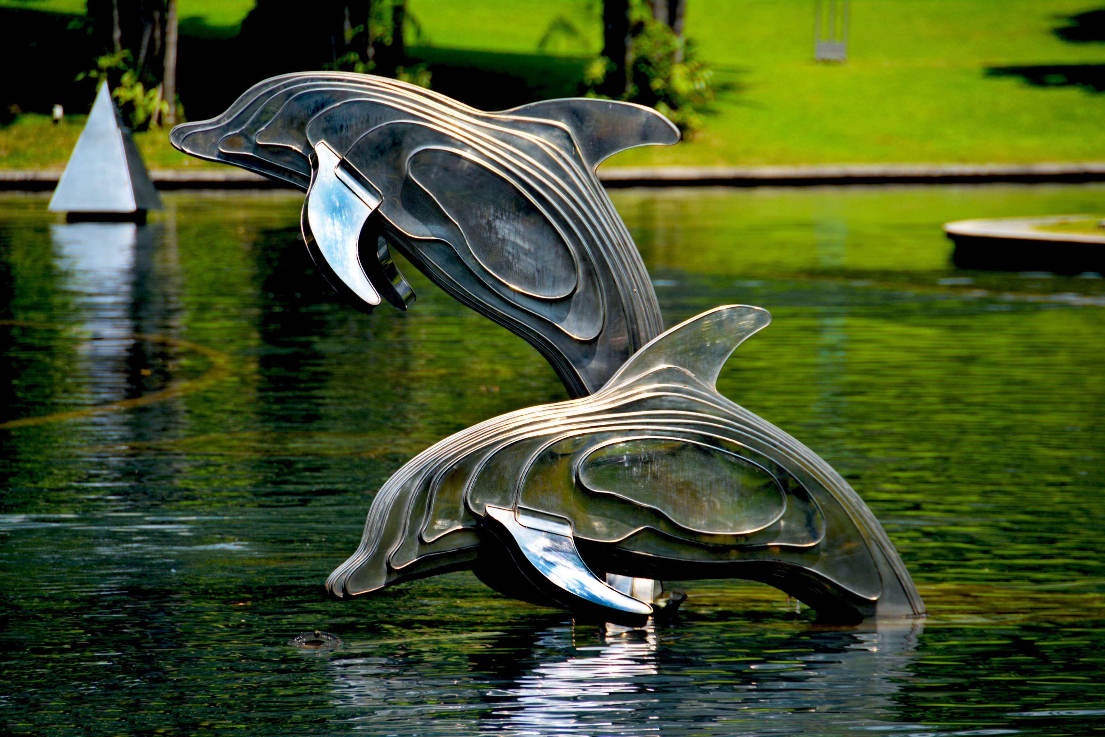 Metal Dolphin Sculptures in a Pond HD Wallpaper