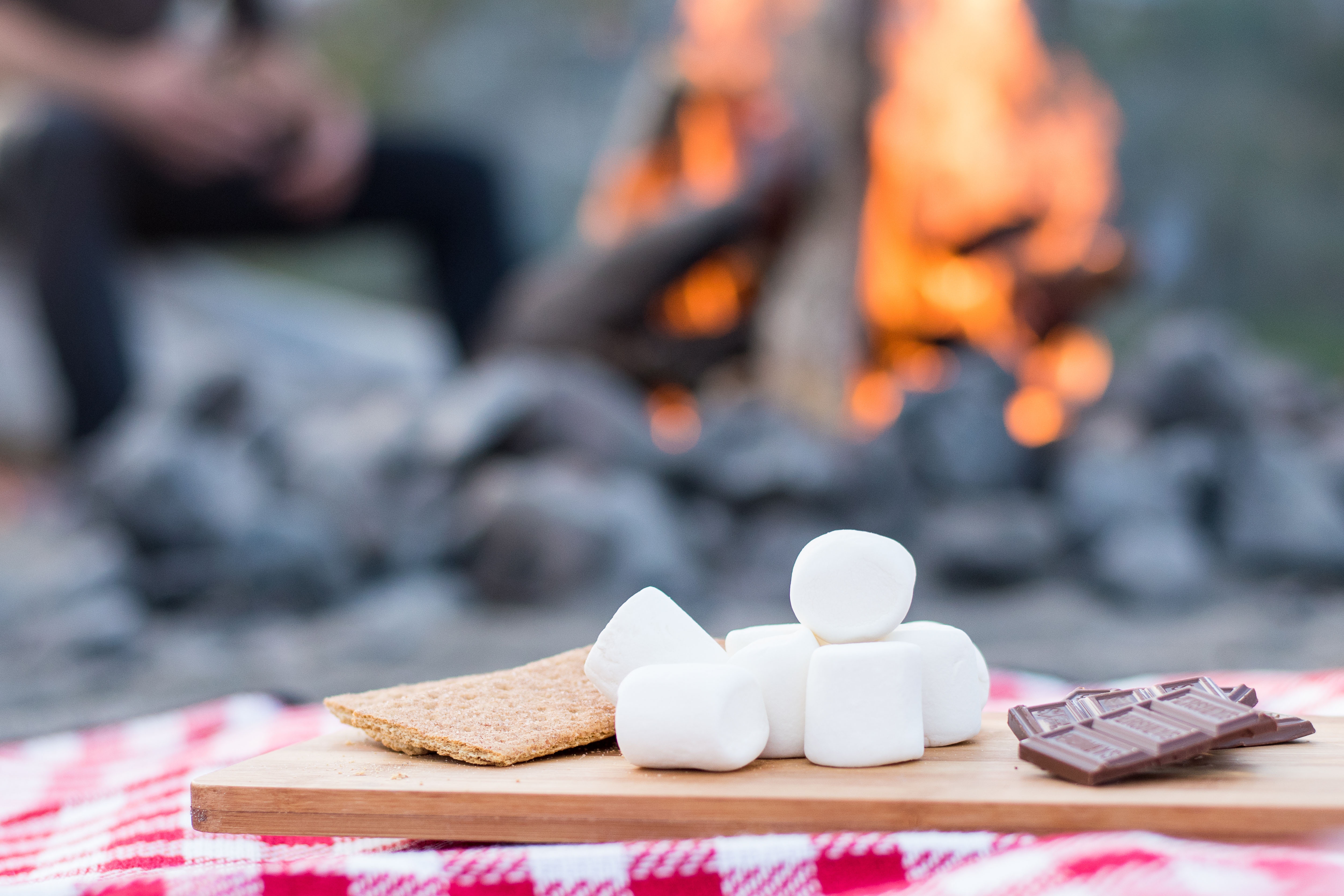 S'mores ingredients by a campfire HD Wallpaper
