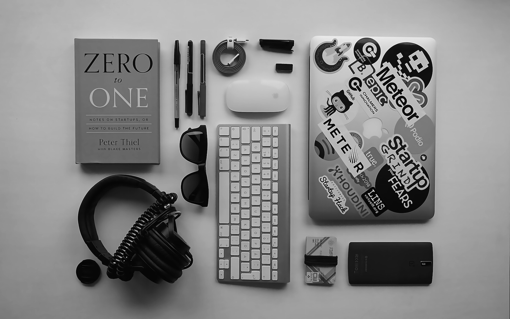 Peter Thiel's Zero to One book with tech accessories HD Wallpaper