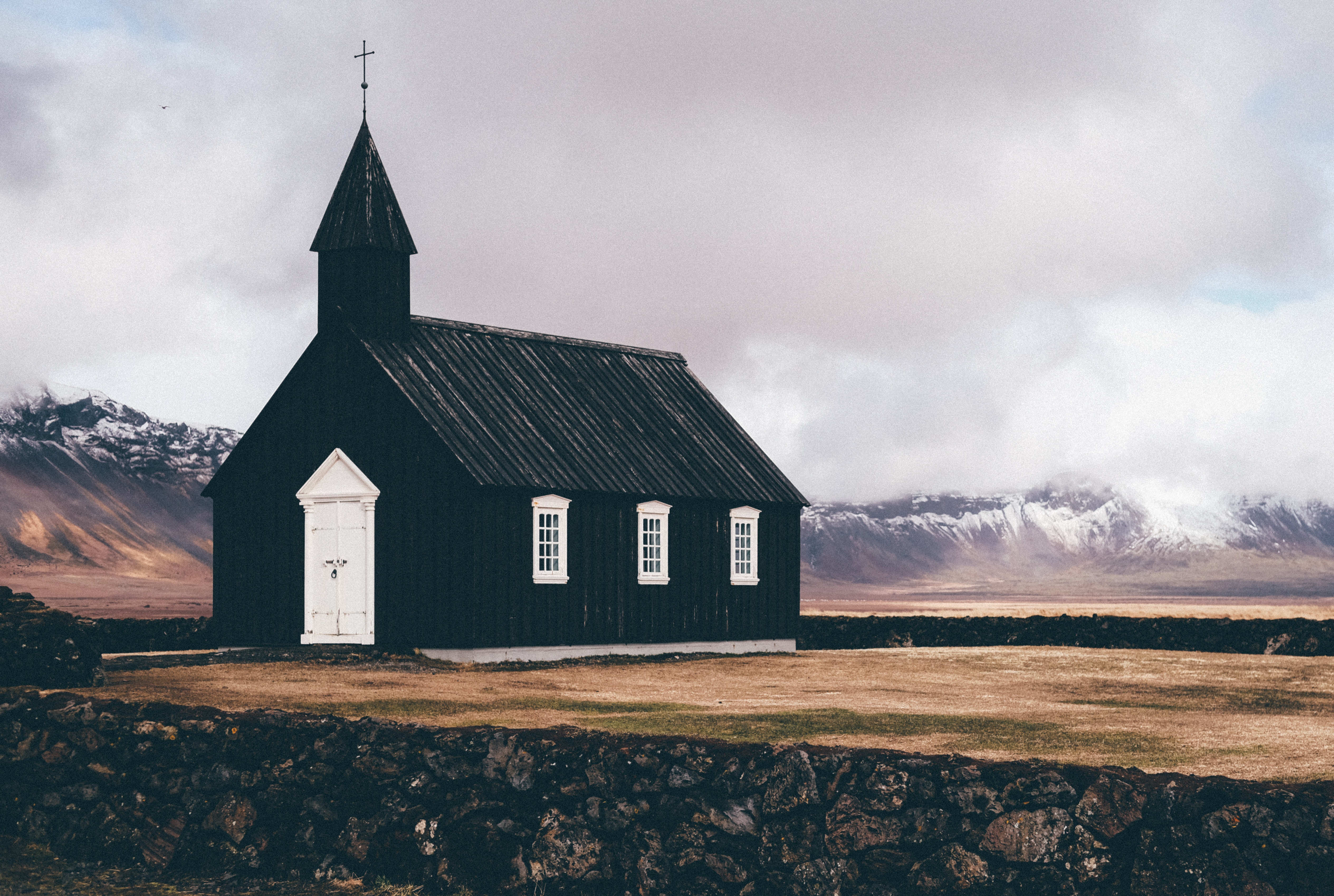 Black wooden church in Iceland with mountains HD Wallpaper