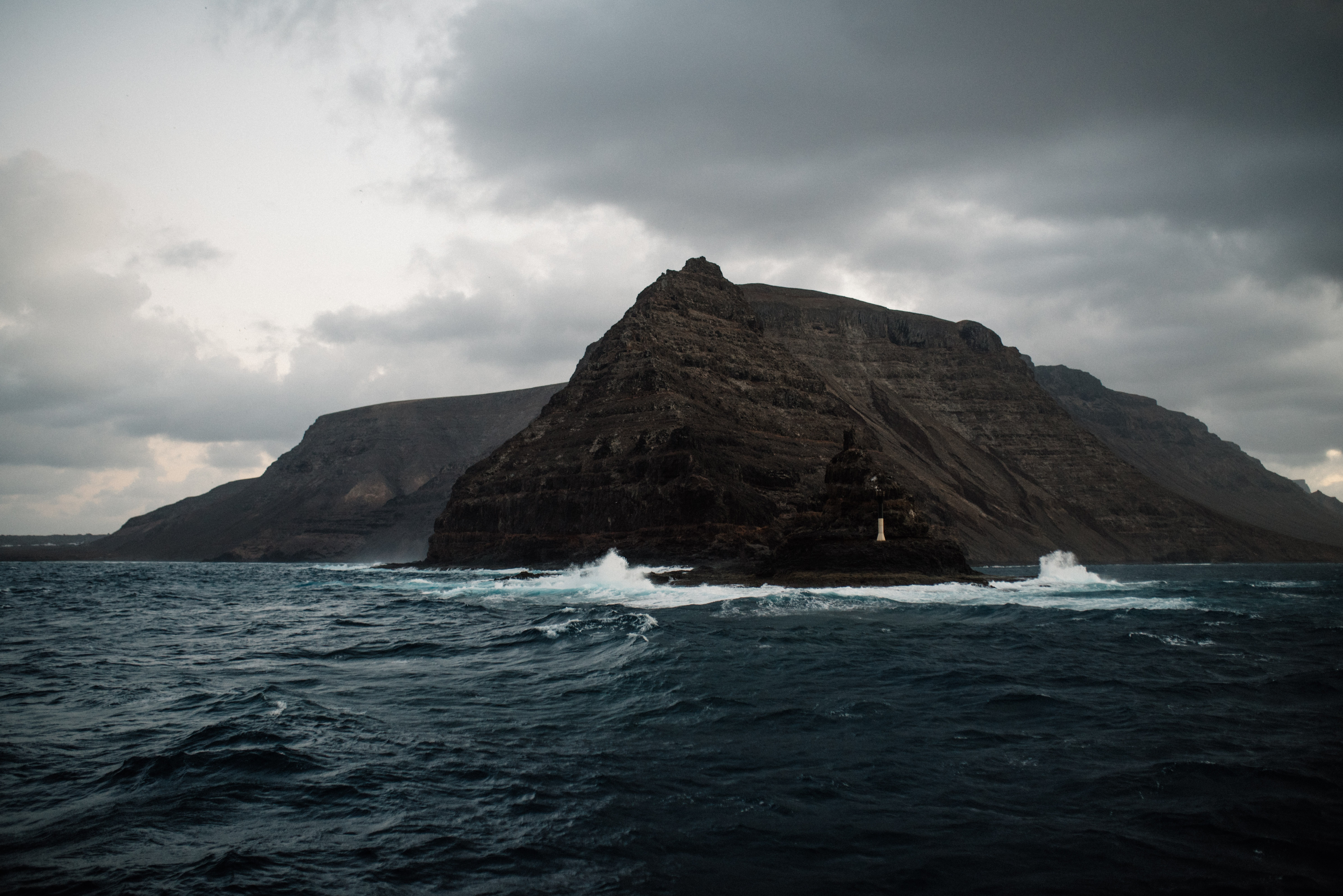 Rocky Coastal Mountain Under Cloudy Sky HD Wallpaper