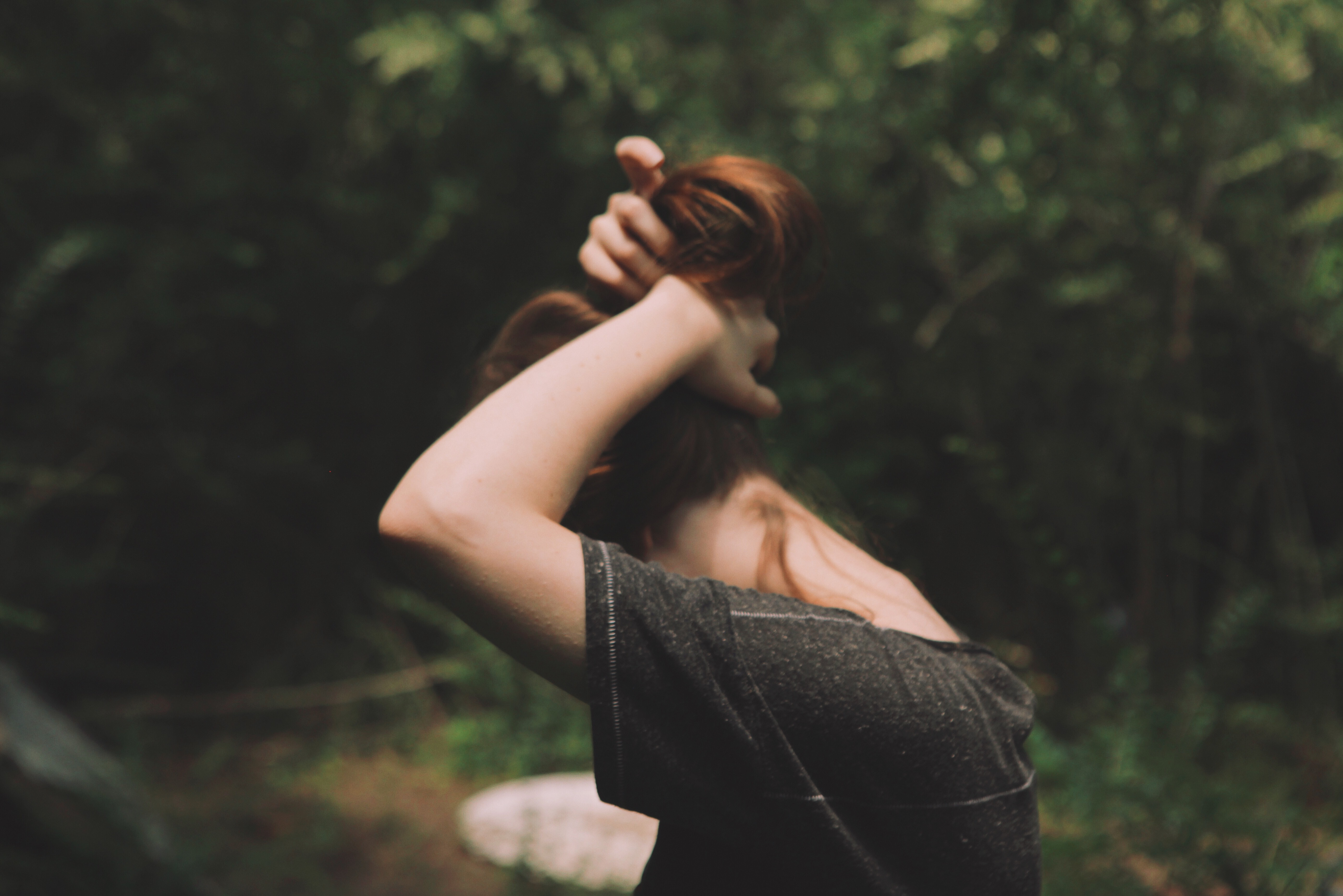 Woman with red hair in a forest HD Wallpaper
