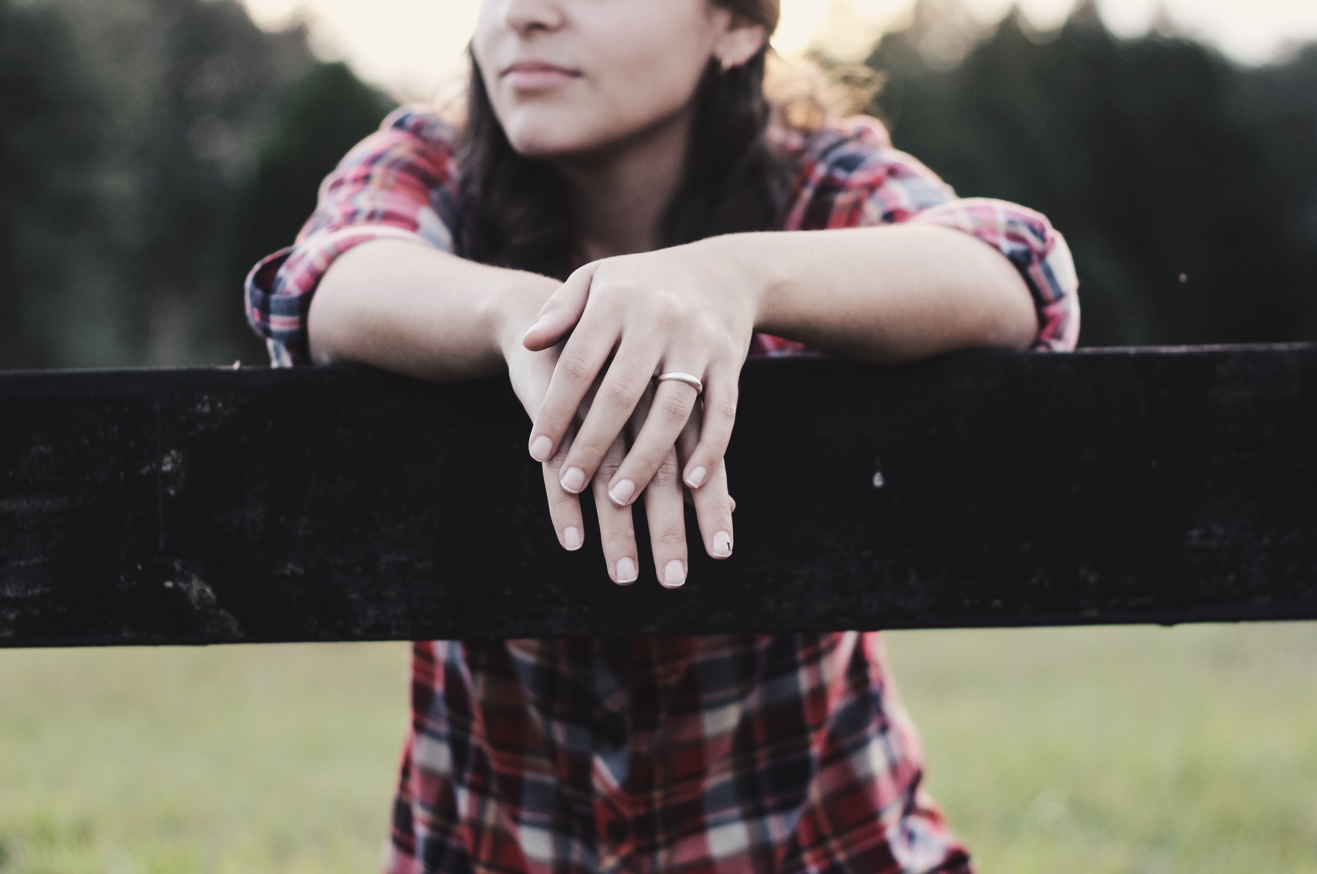 Woman in Flannel Leaning on a Fence HD Wallpaper