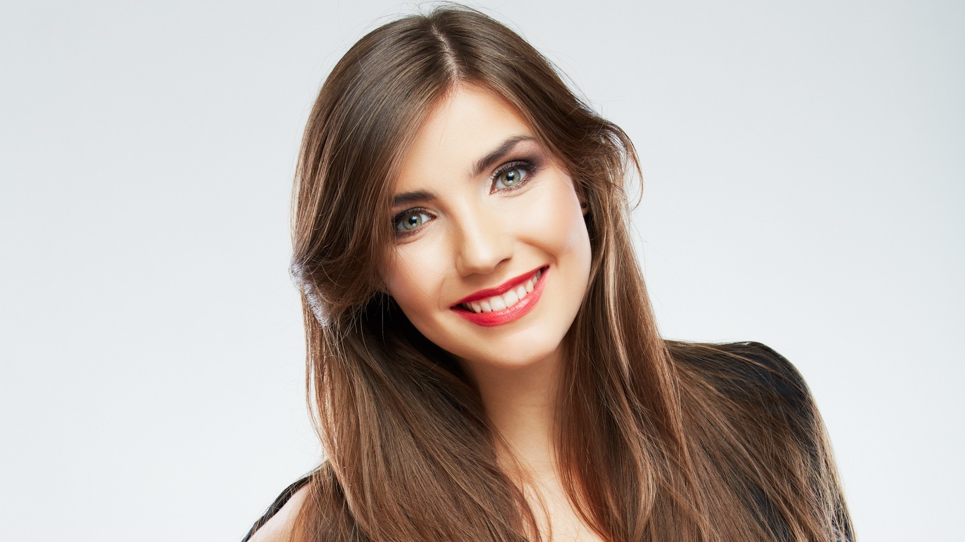 Young woman with long brown hair smiling HD Wallpaper