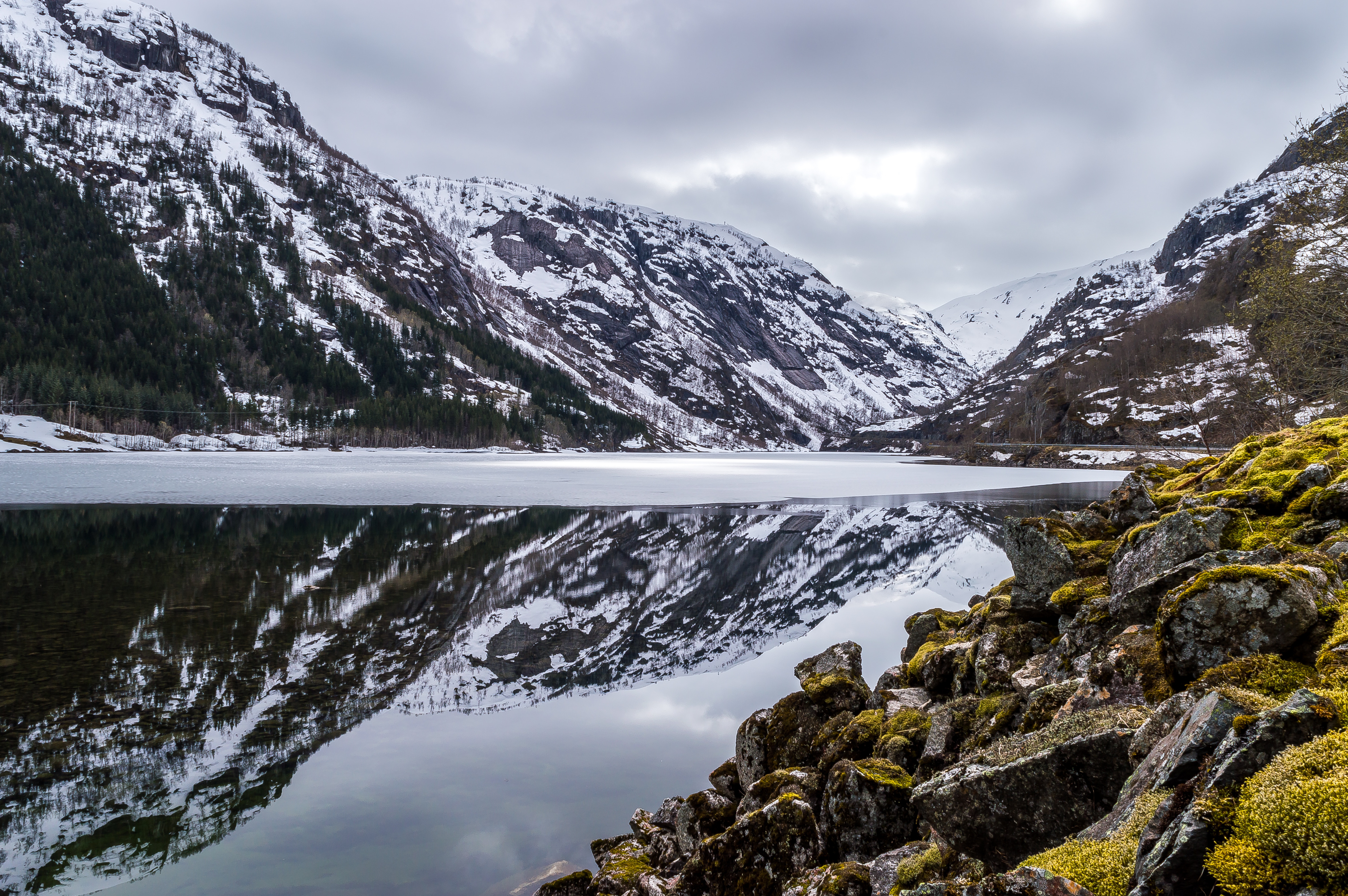 Snow-capped mountains reflected in a calm lake HD Wallpaper