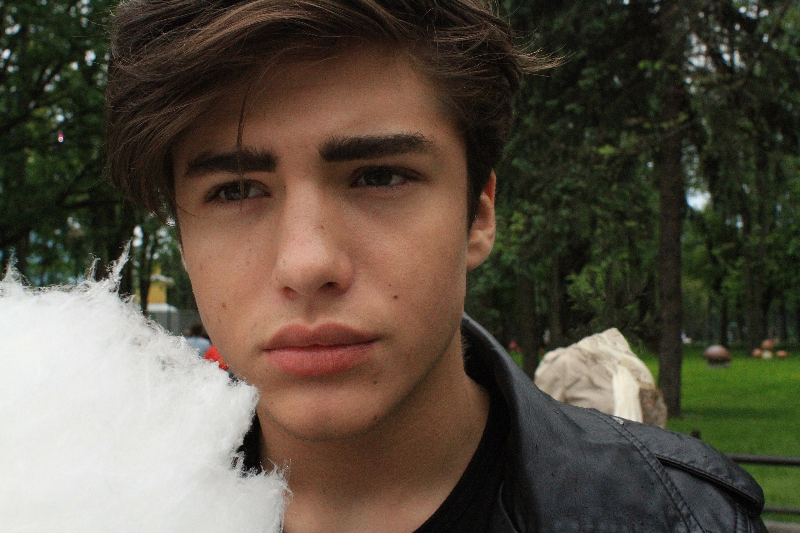 Boy with cotton candy in a park HD Wallpaper