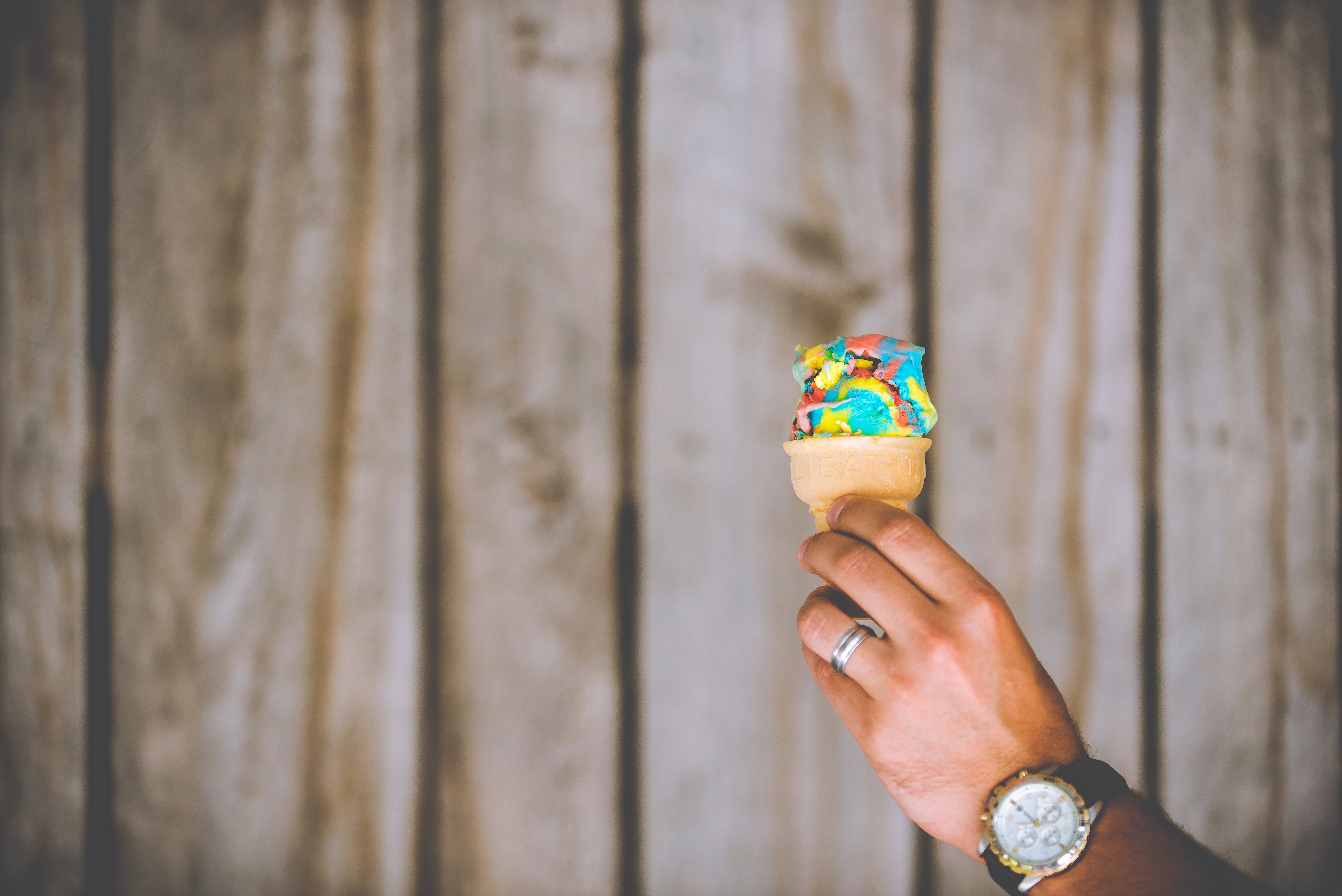 Person holding a colorful ice cream cone HD Wallpaper