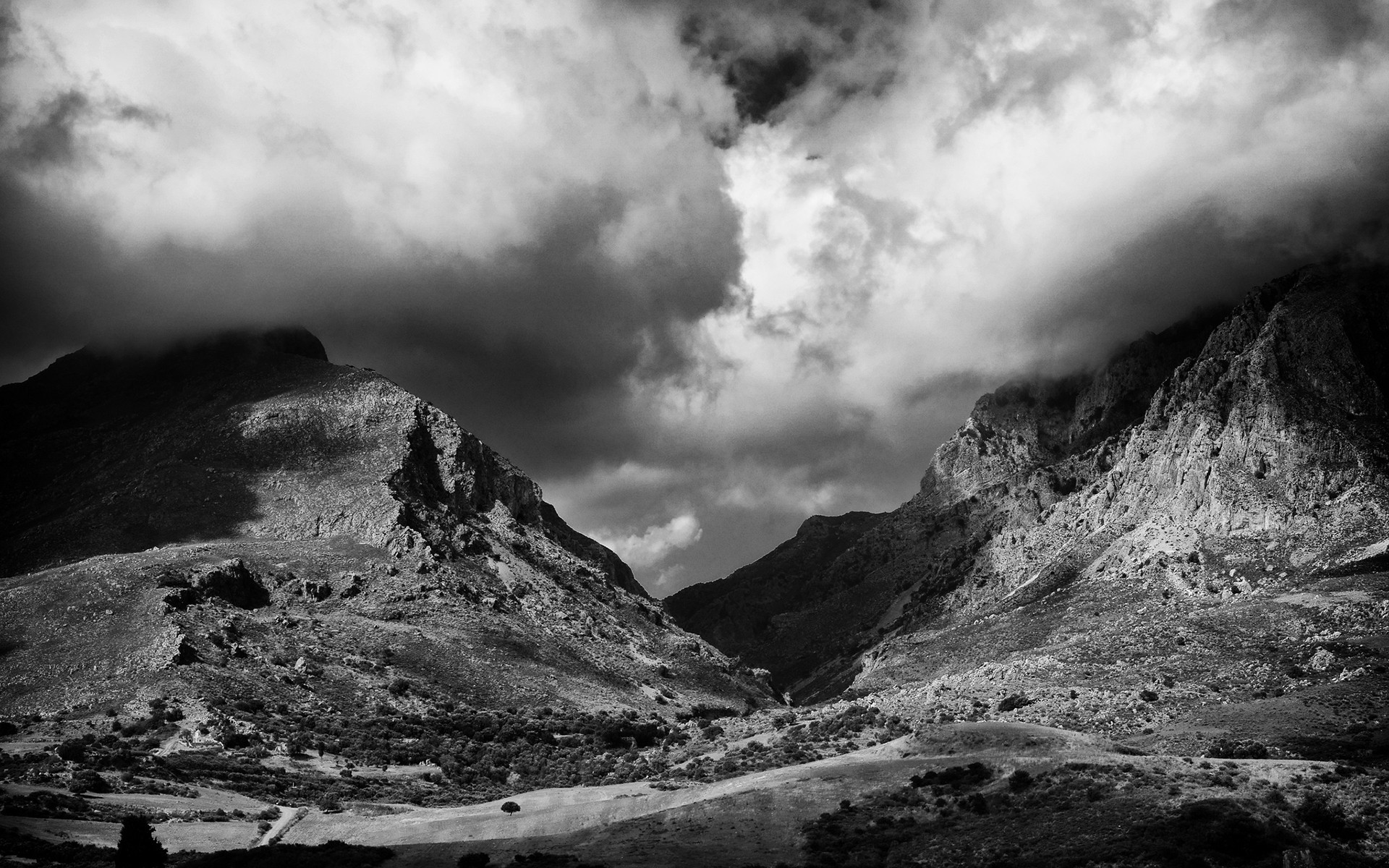 Mountains and dramatic clouds in black and white HD Wallpaper