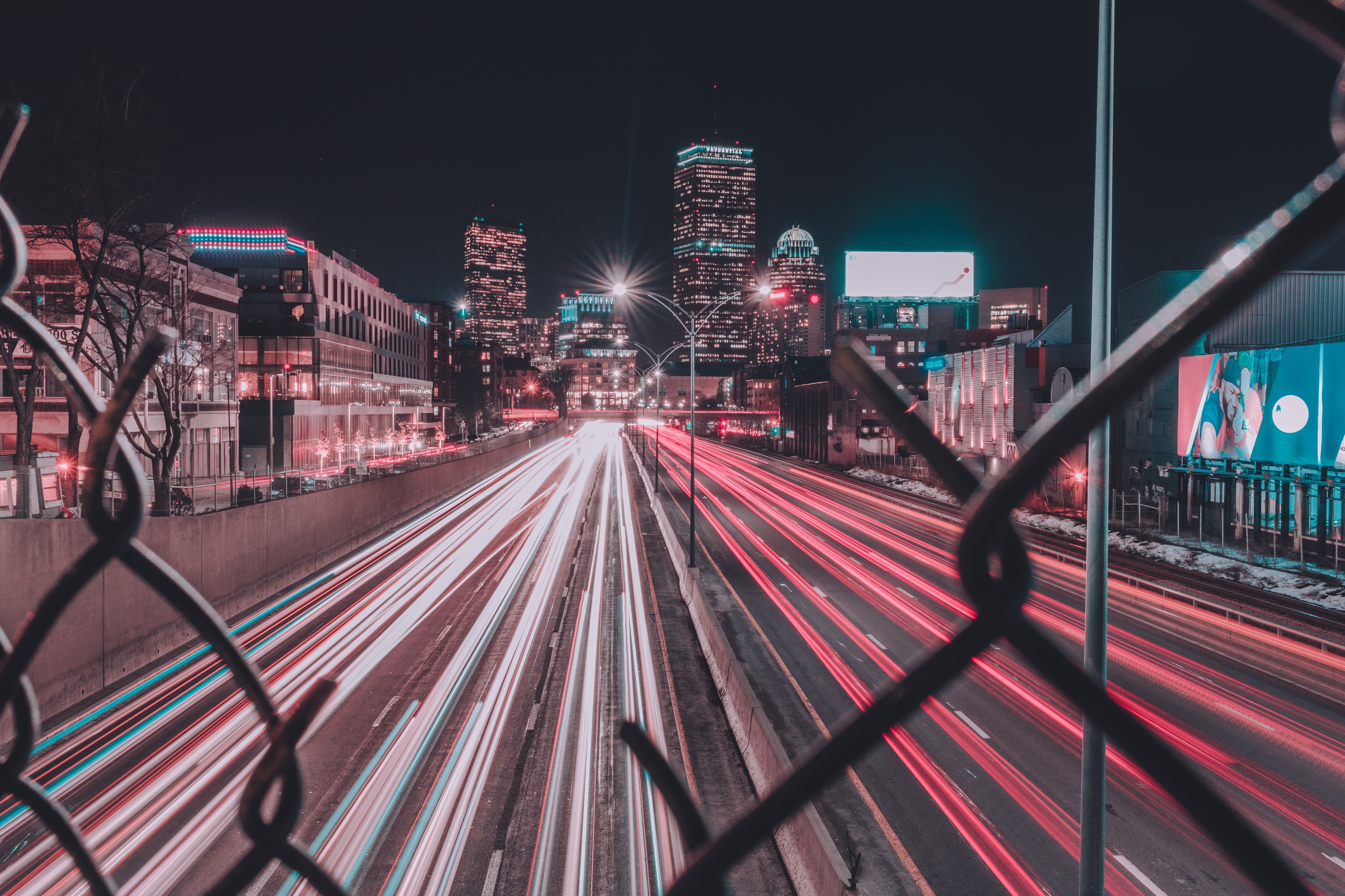 Cityscape with light trails on highway at night HD Wallpaper